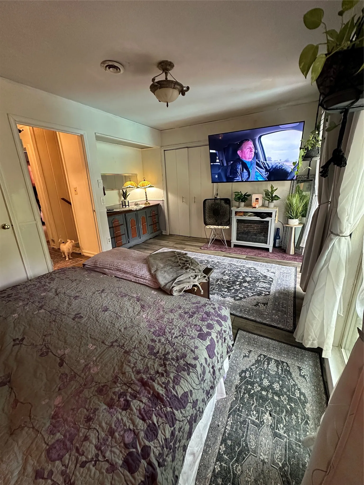 Spacious room featuring wood-finish flooring and a ceiling-mounted light fixture