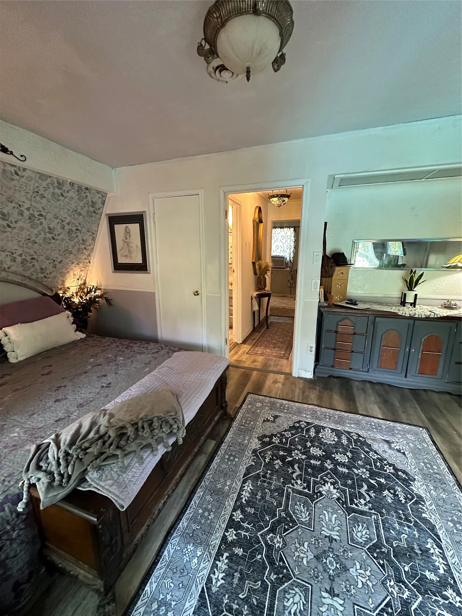 Interior space featuring wood-finish flooring and a decorative ceiling fixture