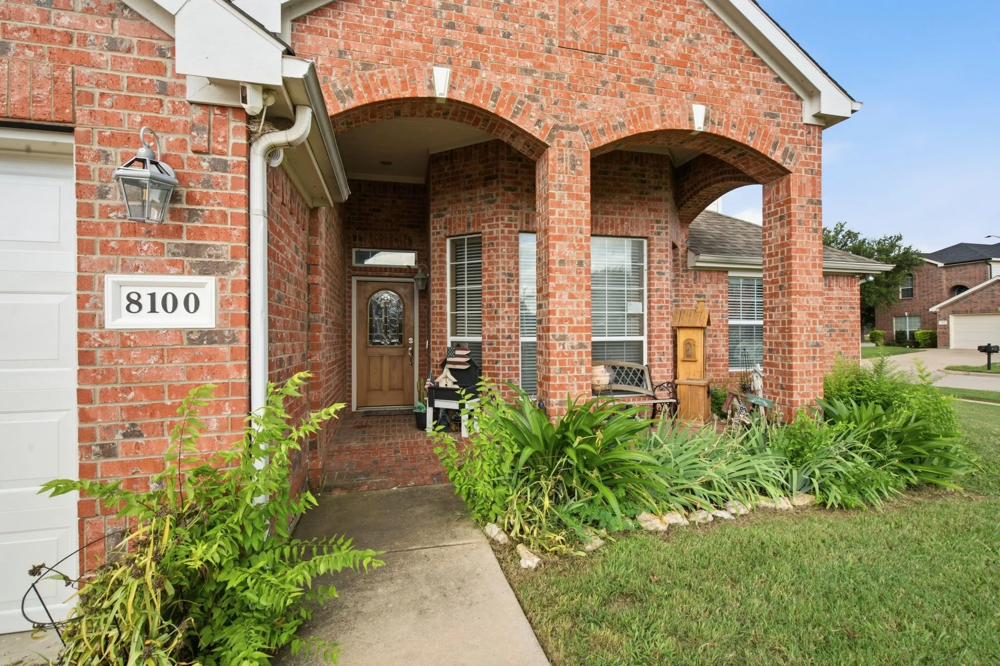 Brick facade with an arched entry porch