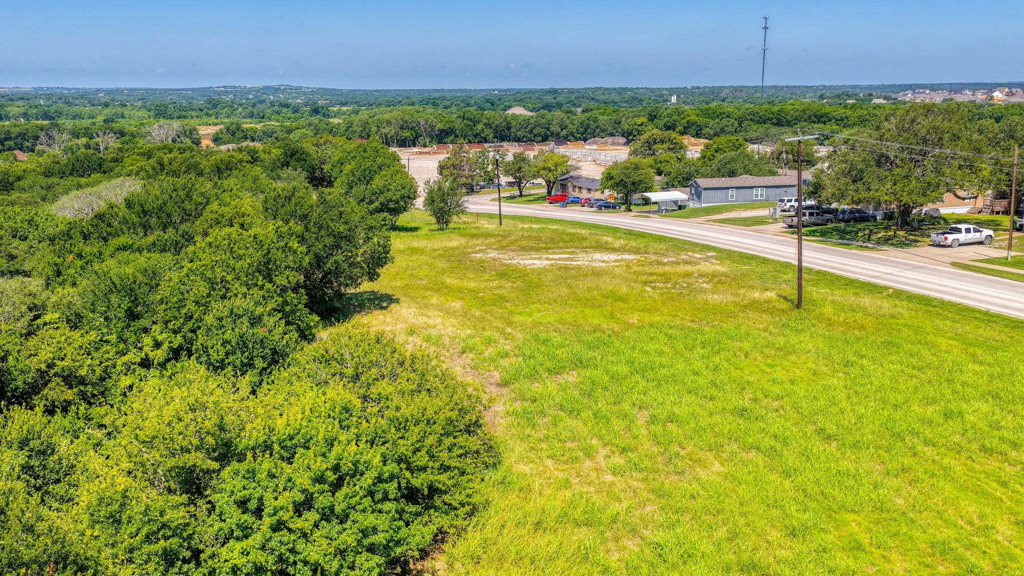 Expansive undeveloped land featuring a combination of dense tree cover and open grassy areas
