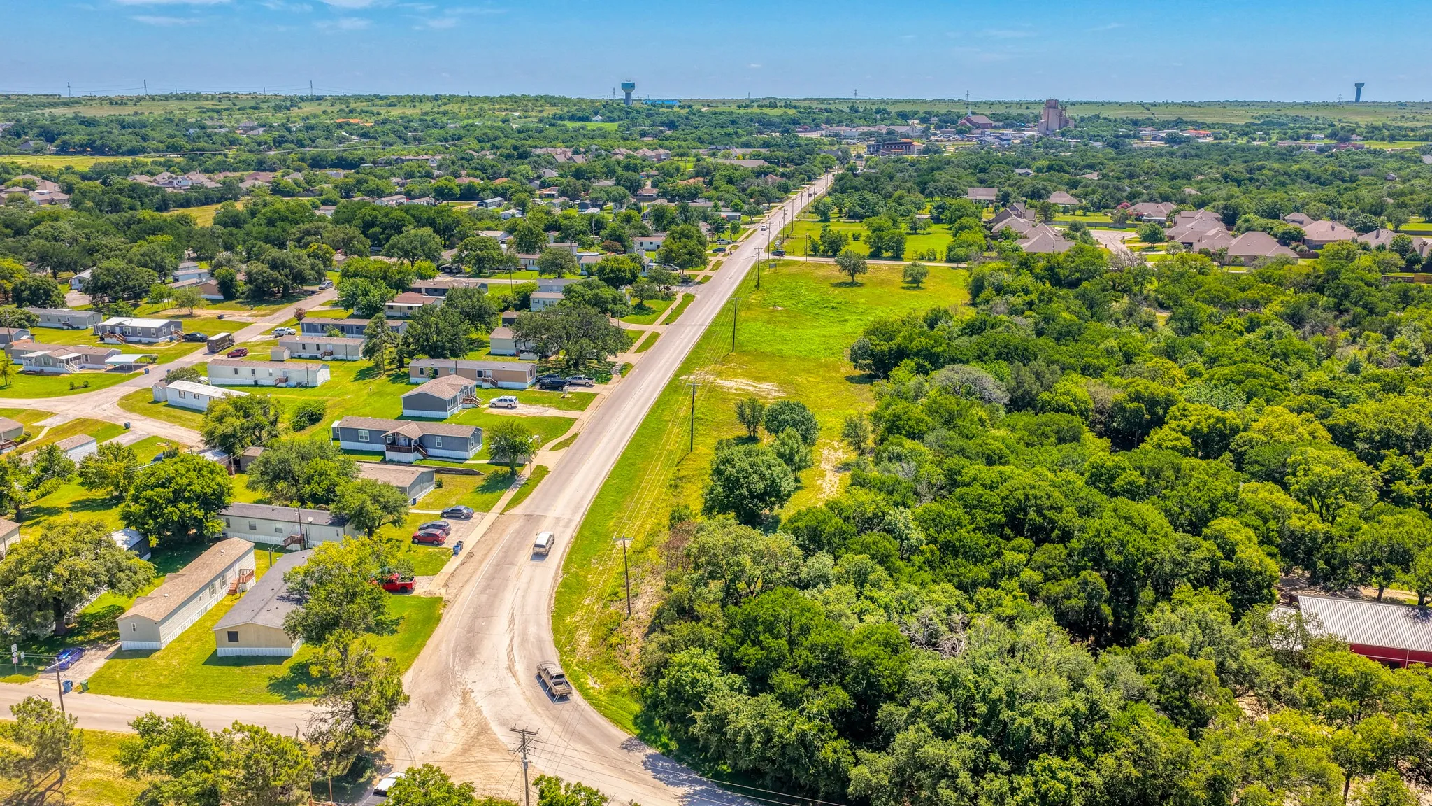 Expansive aerial view showcasing a diverse landscape of residential areas and extensive green spaces