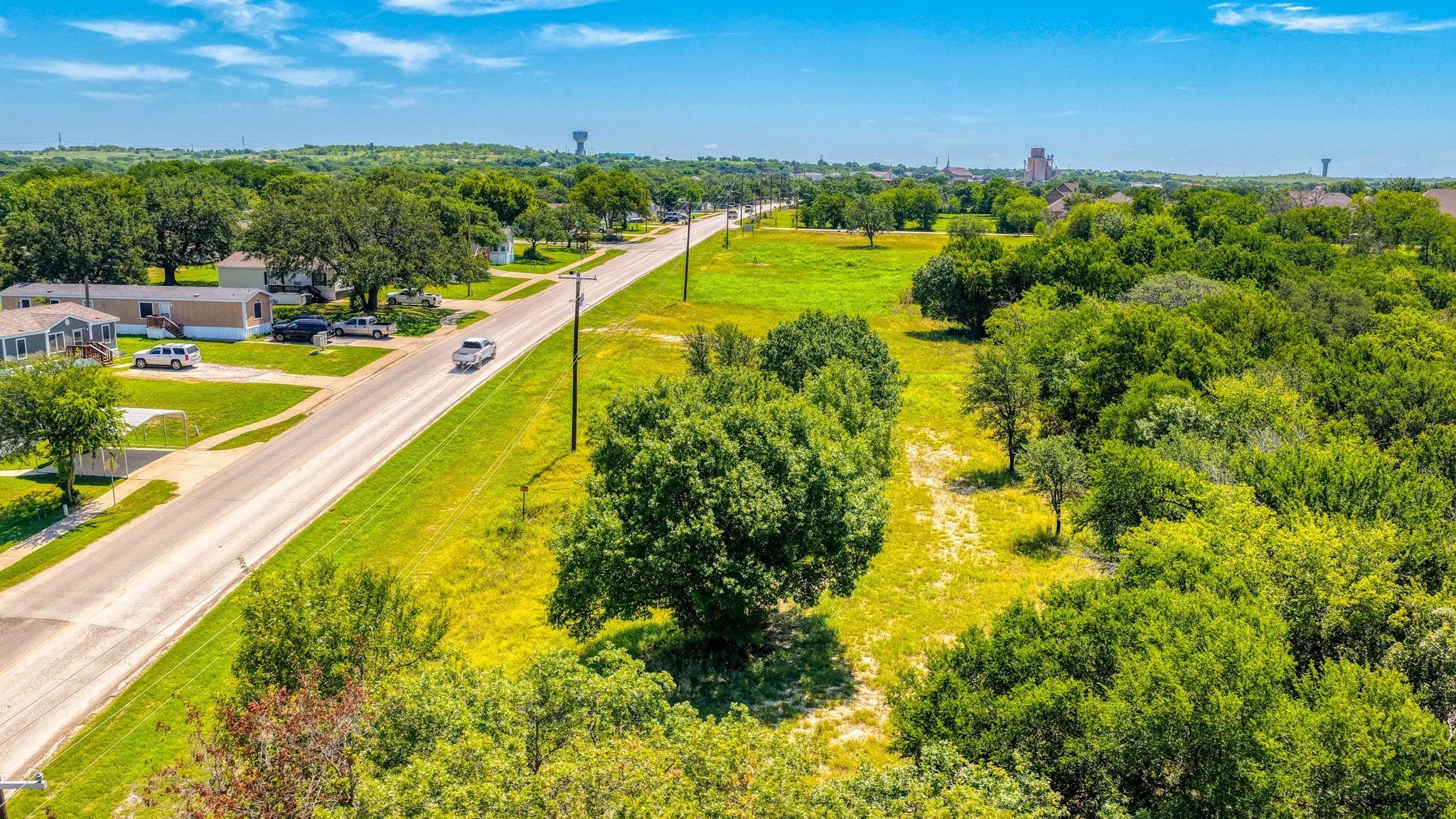 Expansive undeveloped land featuring mature trees and a flat topography