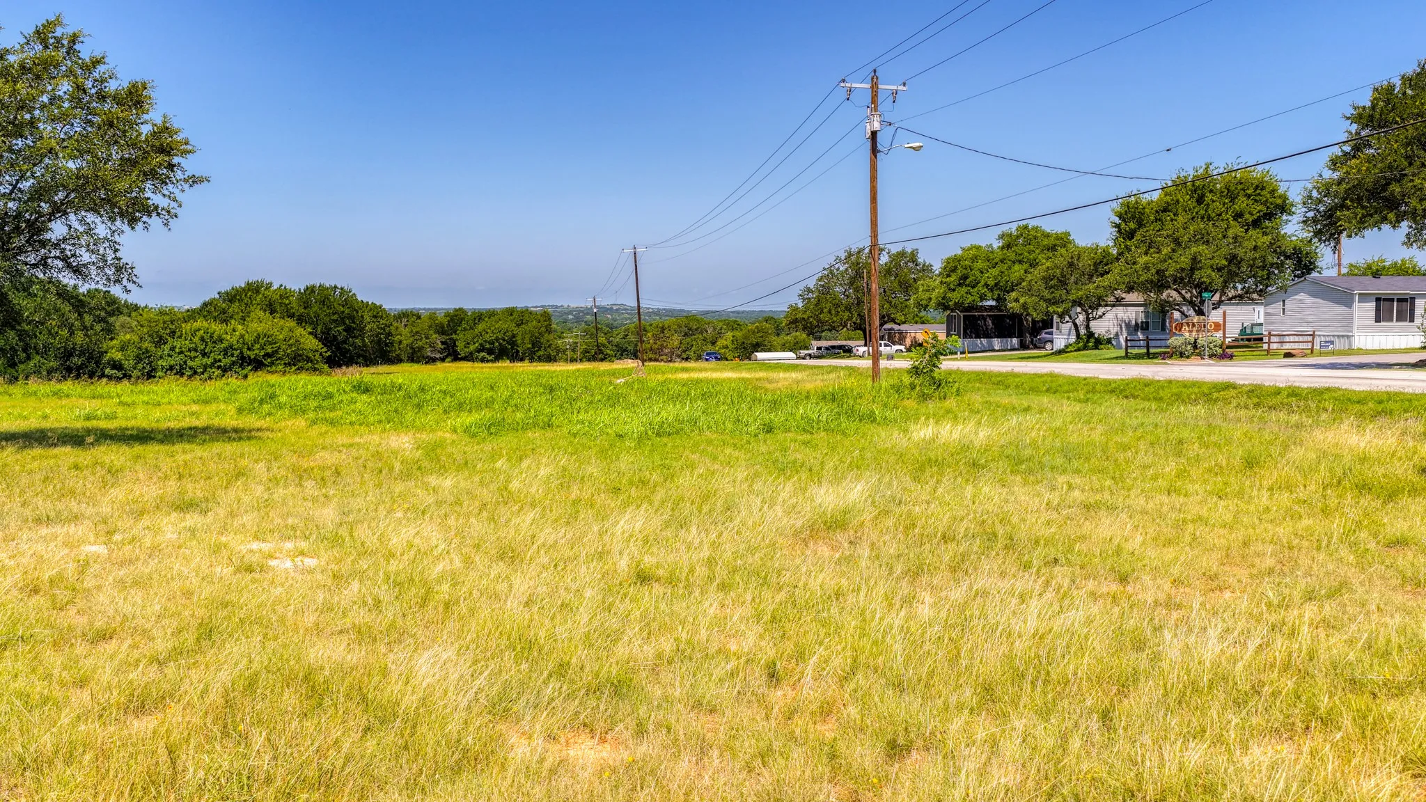 Expansive grass field with varied green and golden tones