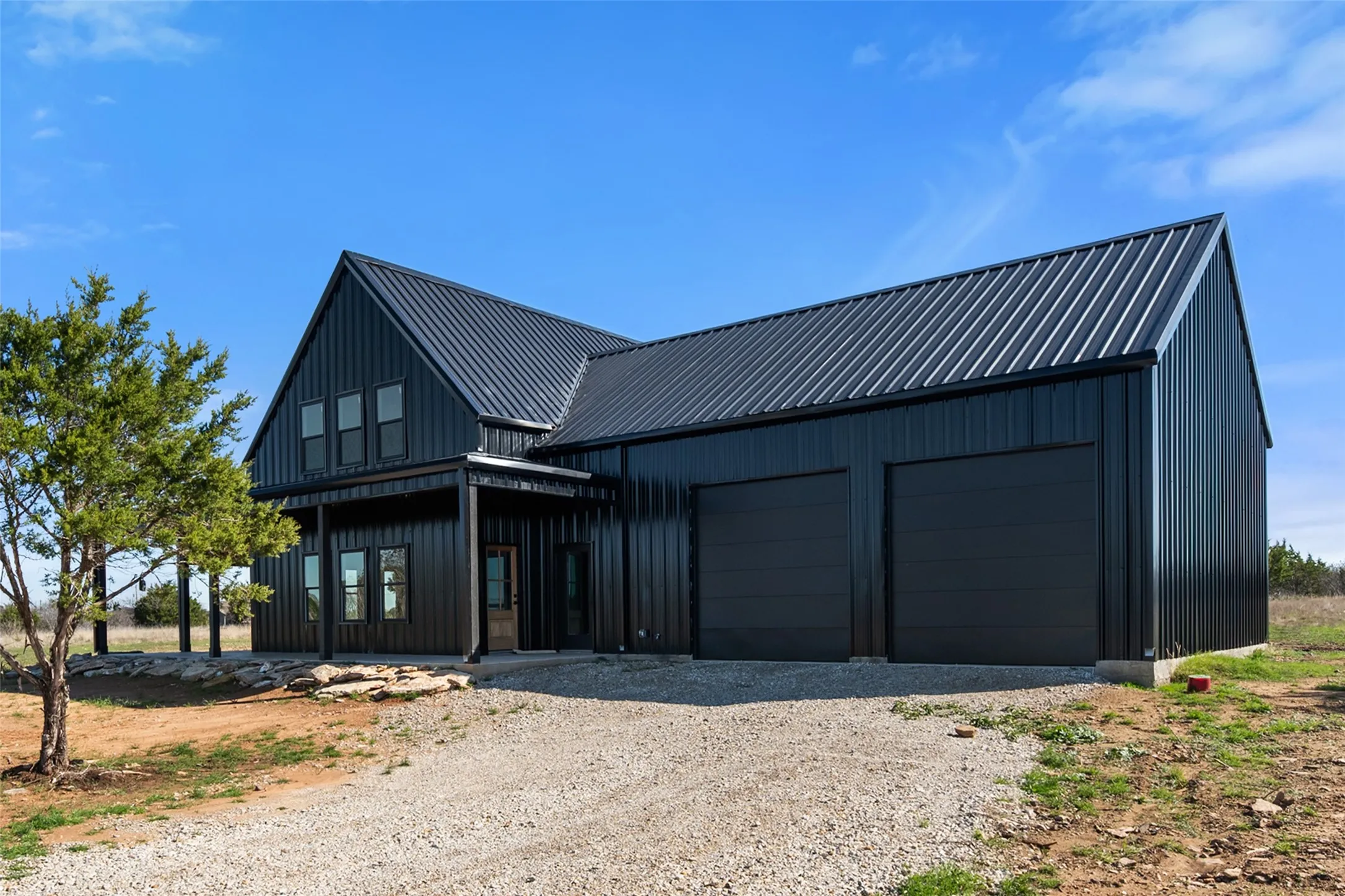 Modern black metal-sided exterior with a matching metal roof