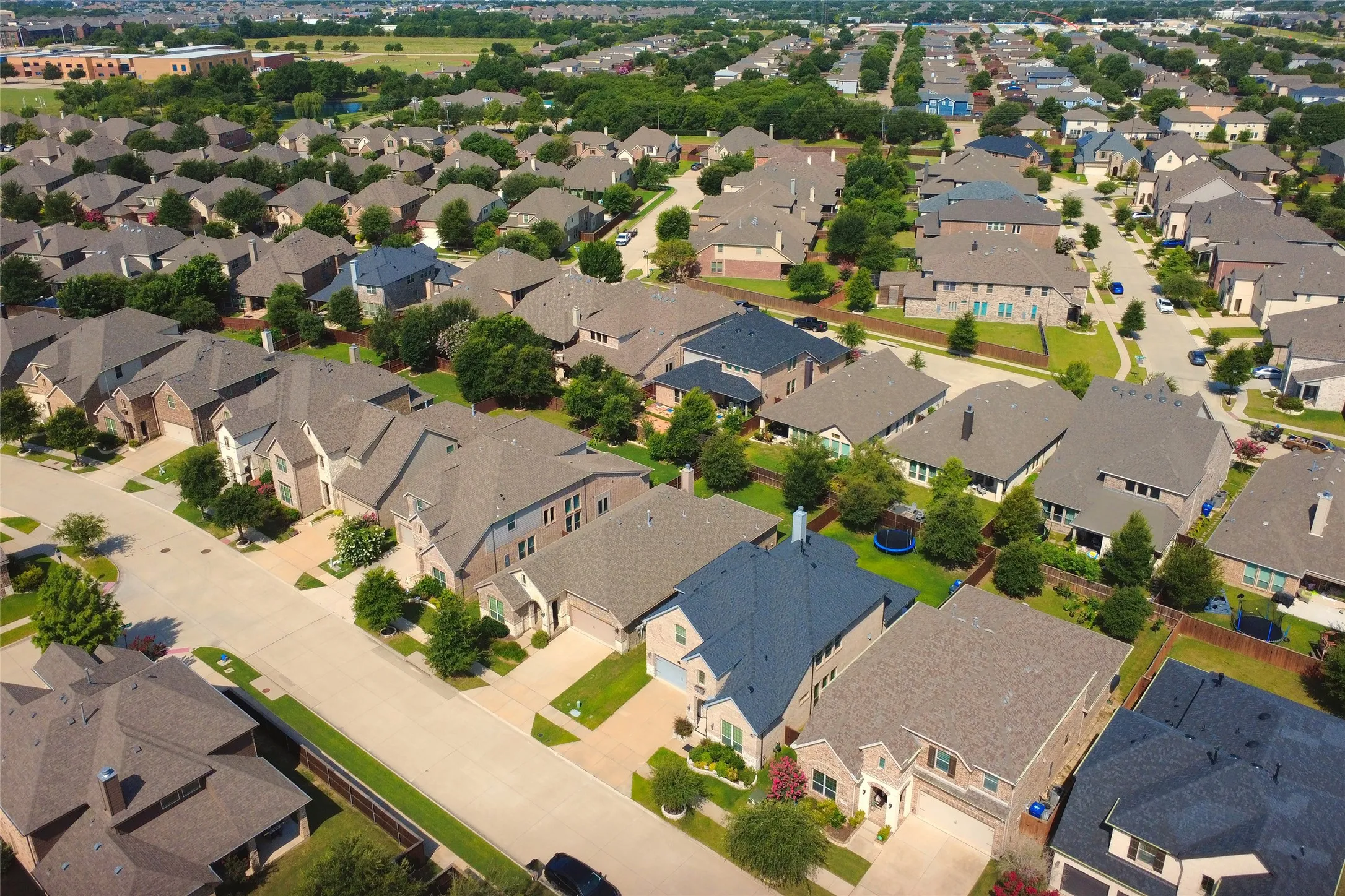 Expansive residential area featuring numerous single-family homes with varied architectural styles, mature landscaping, and an organized street grid