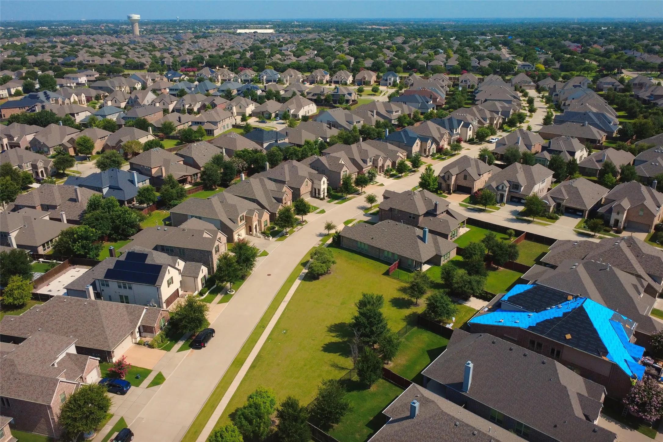 Expansive aerial view showcasing a residential neighborhood with diverse architectural styles