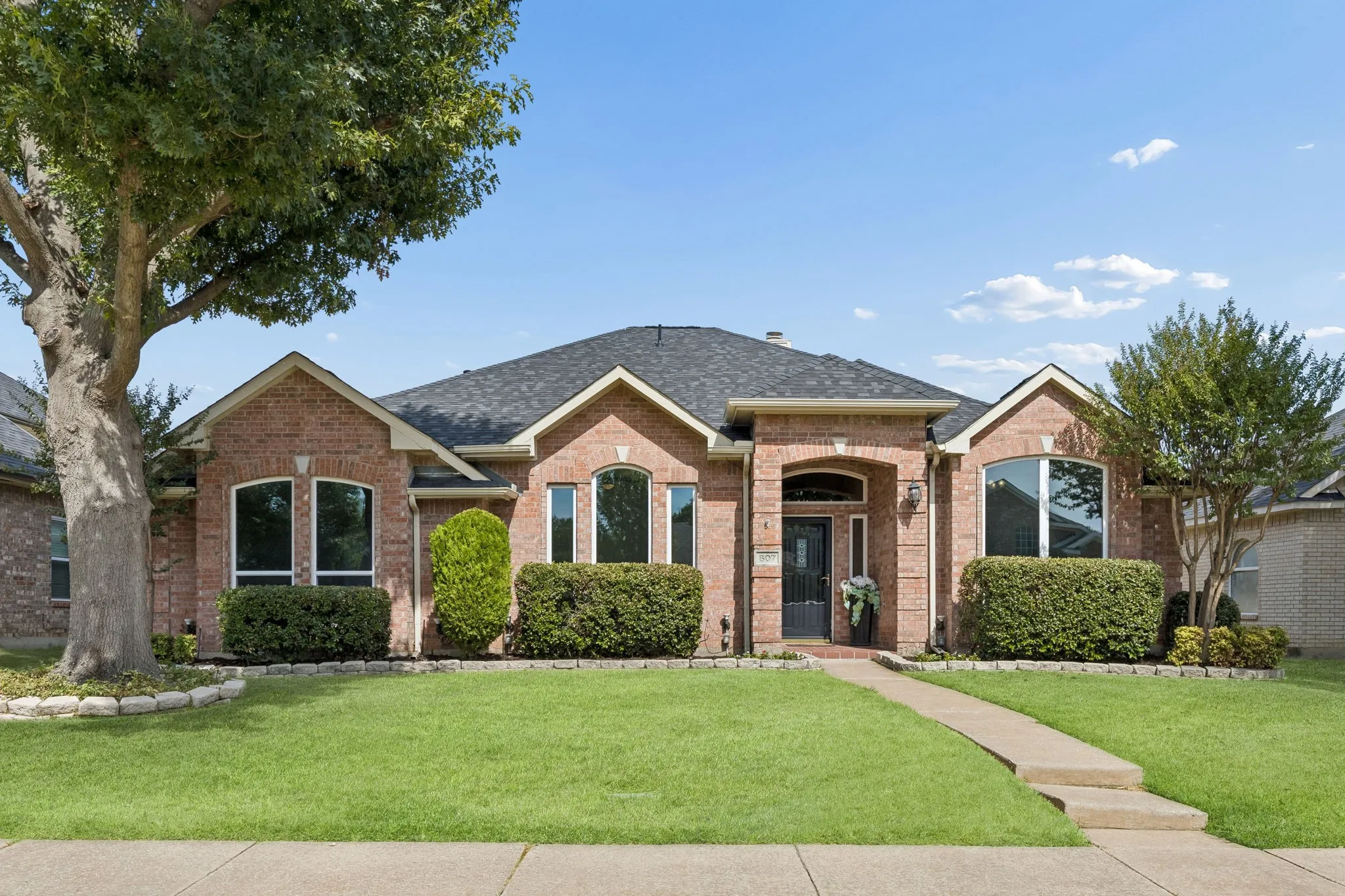 Welcome to 607 Grimsworth Court in Allen. Well maintained lawn and trimmed shrubbery in stone bordered beds provide lovely drive up appeal.