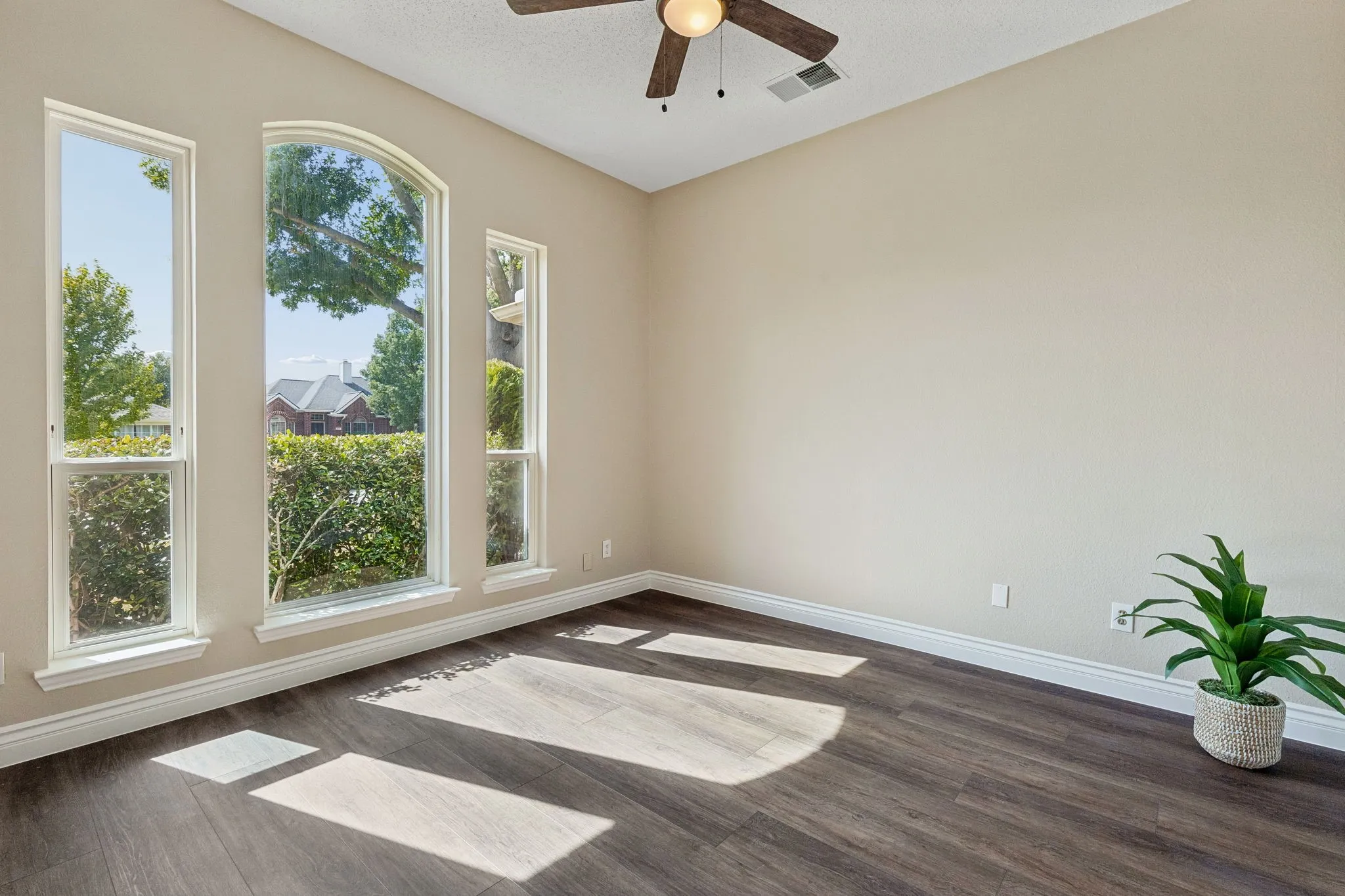 This bedroom toward the front of the home is
currently used as an office. The room boasts New LVP flooring, fresh paint, and a ceiling fan.