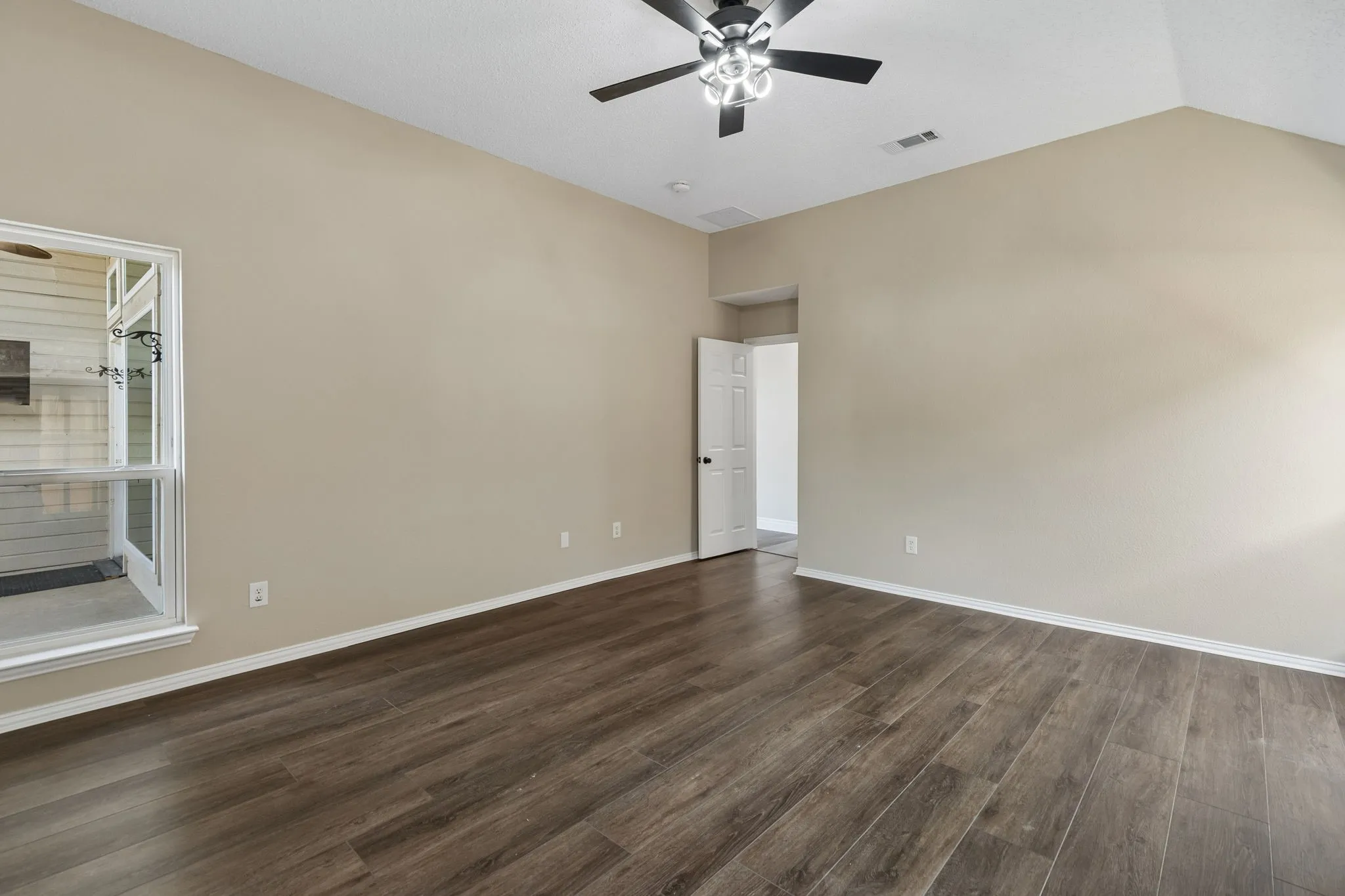 The updated primary bathroom has great storage along with quartz countertops, white cabinets and wave sinks.