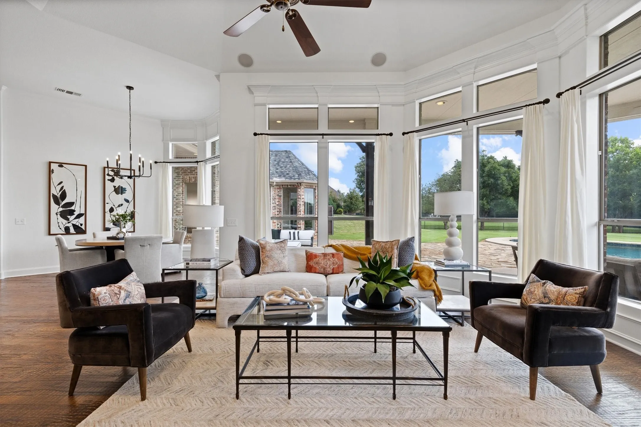 Open-concept living space with expansive bay windows and wood-finish flooring