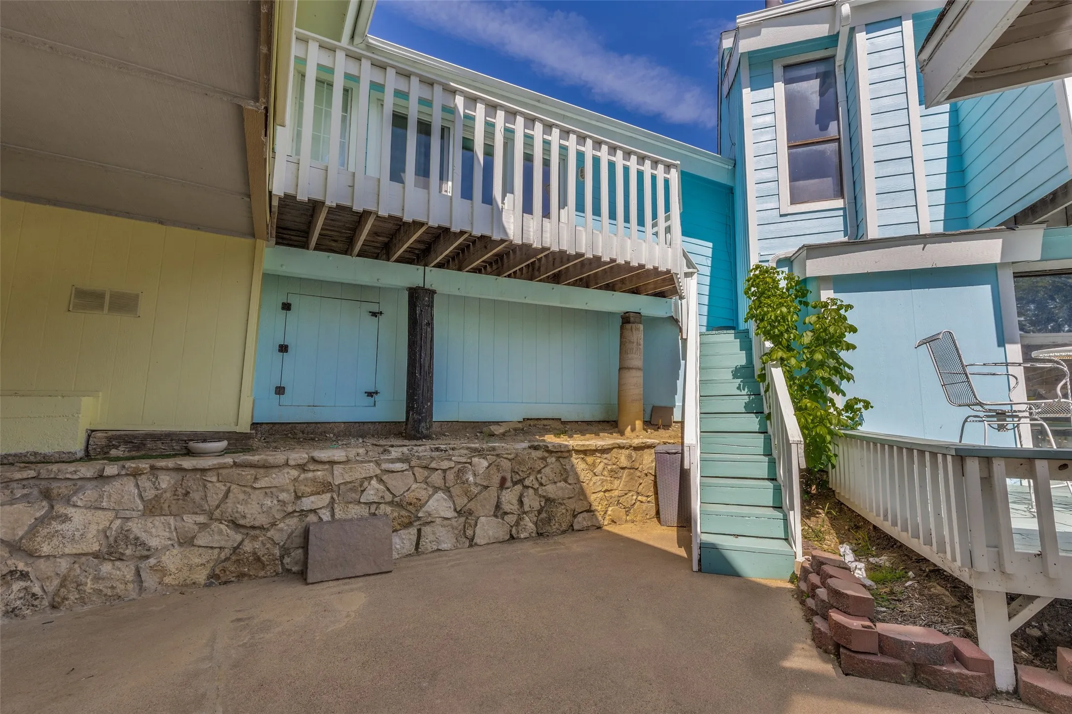 Multi-level exterior with light blue and yellow siding