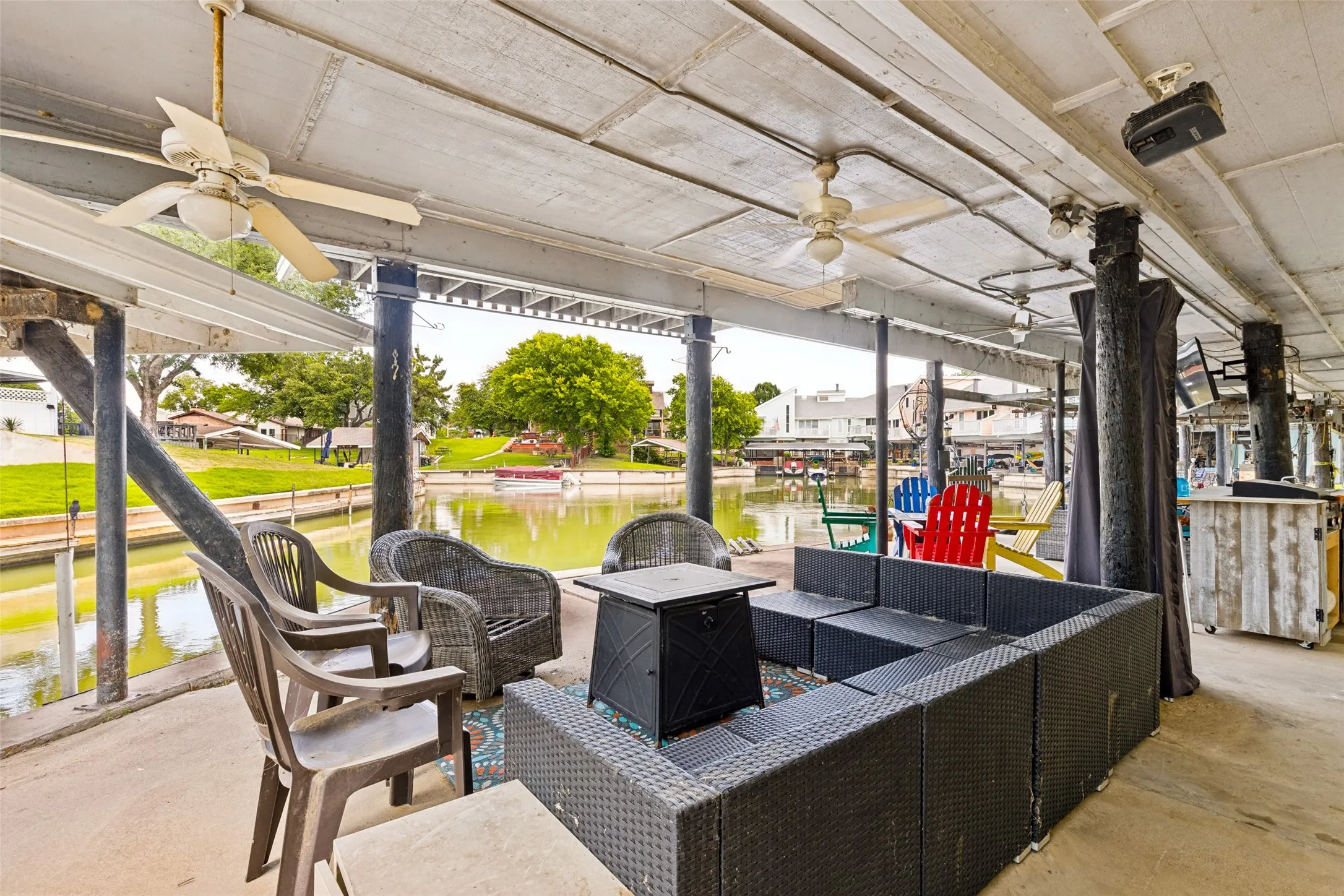 Covered patio featuring a ceiling fan, recessed lighting, and a projector