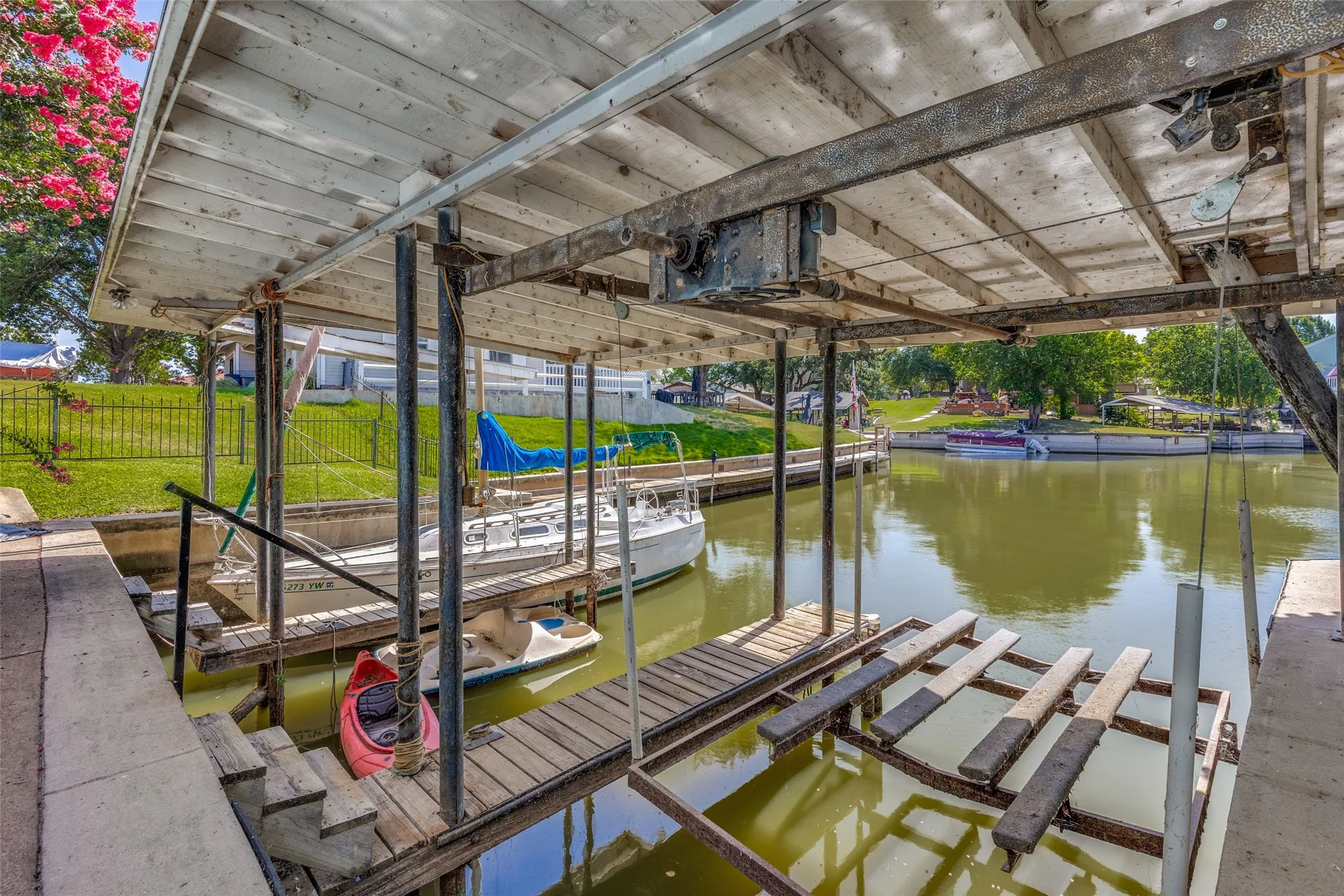 Private boat dock with covered slips and a boat lift mechanism