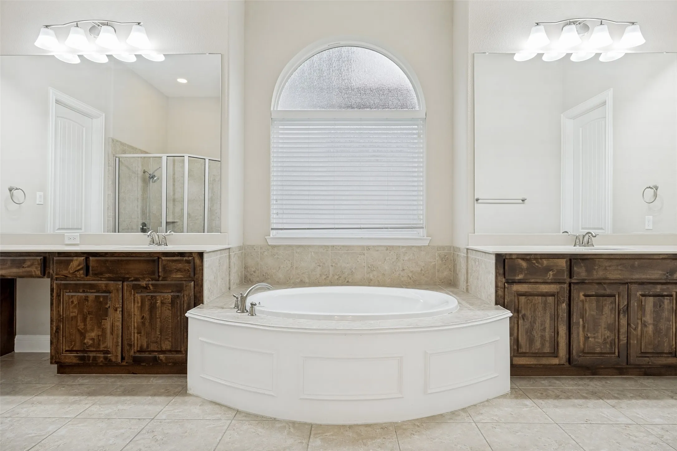 Soaking tub with tiled surround and an arched window