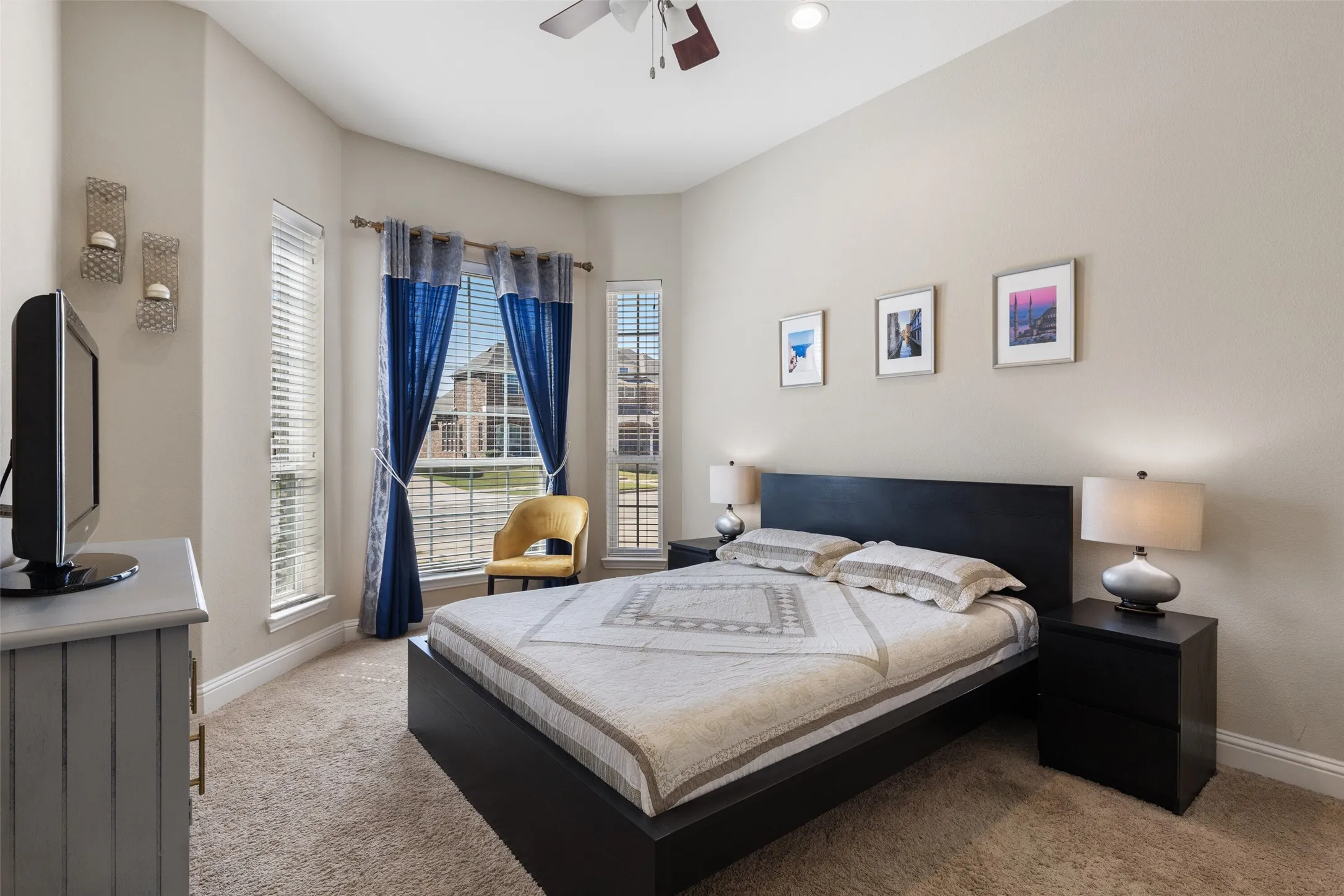 Bedroom featuring neutral wall color, carpet flooring, a vaulted ceiling, and multiple windows with blinds