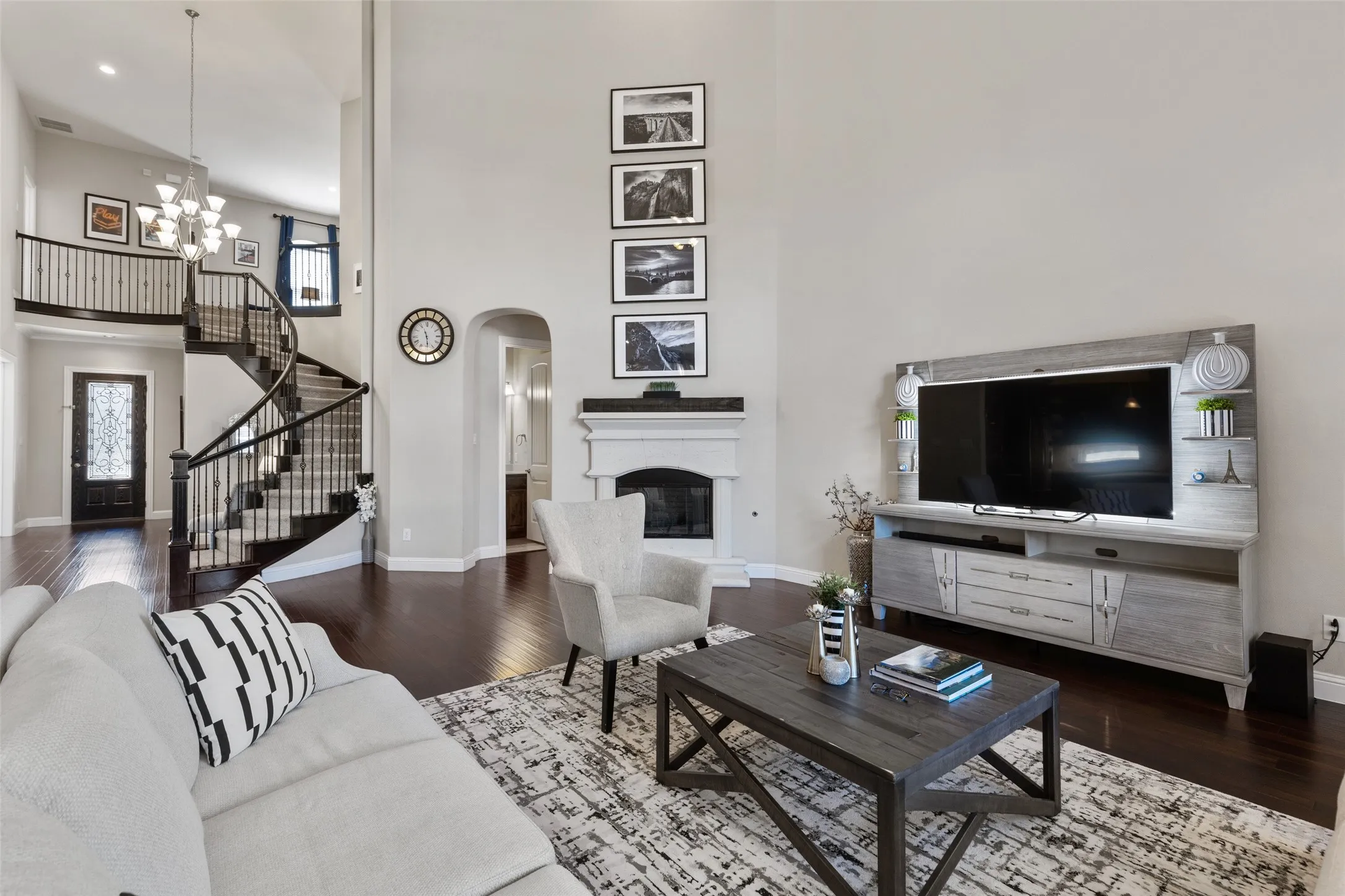 Grand entry featuring a spiral staircase with dark wood treads and wrought iron balusters