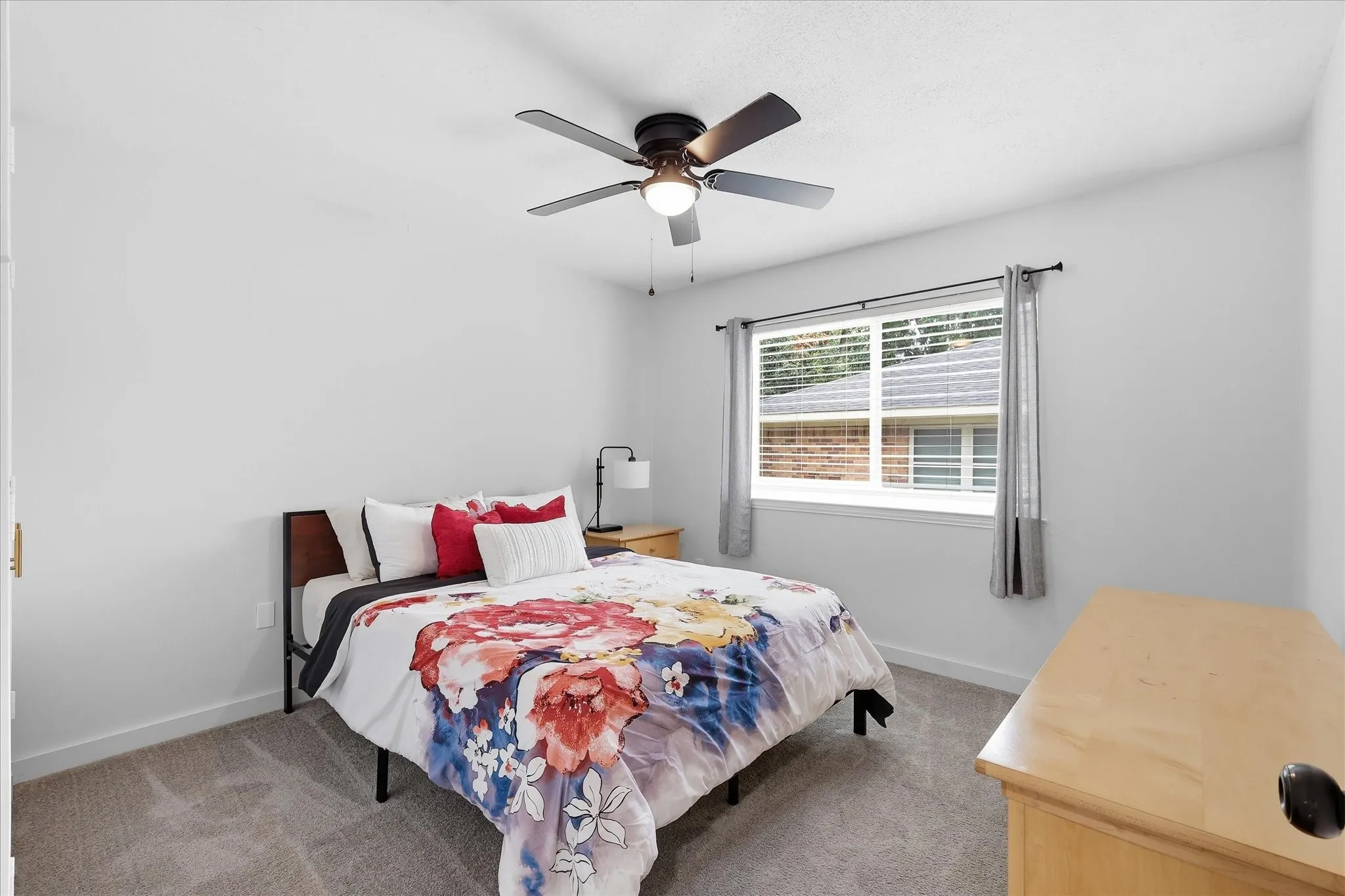 Carpeted room with a ceiling fan, a window with blinds, and white painted walls