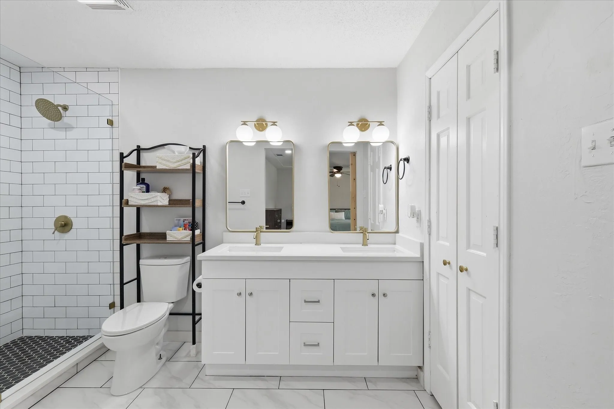 Modern bathroom featuring a dual vanity with white cabinetry and integrated sinks