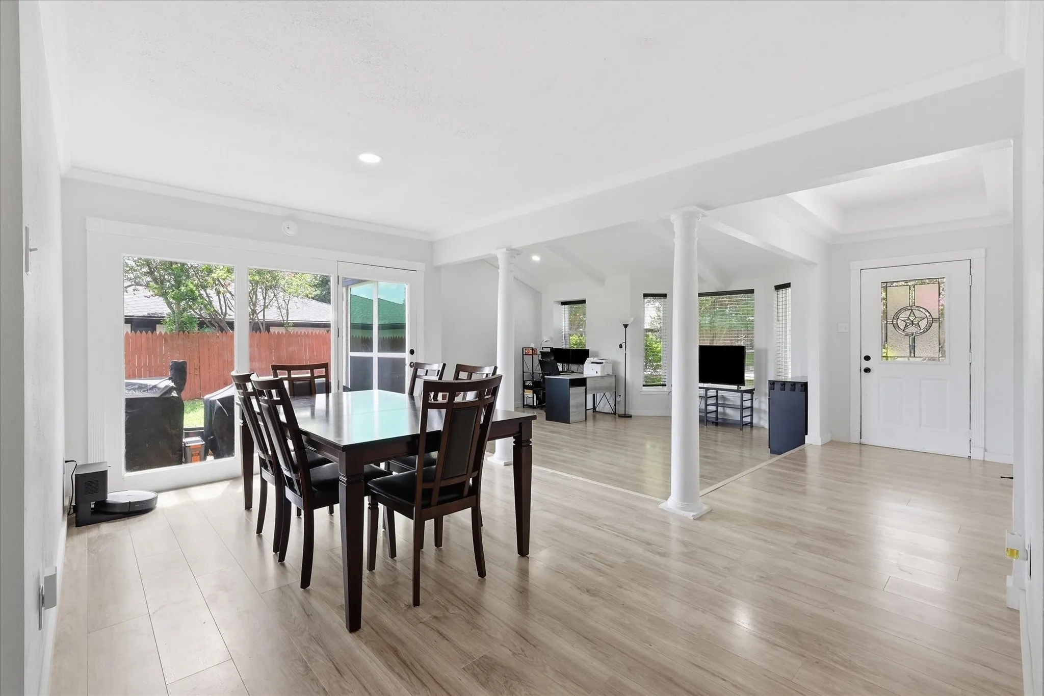 Open-concept interior featuring light wood-finish flooring throughout