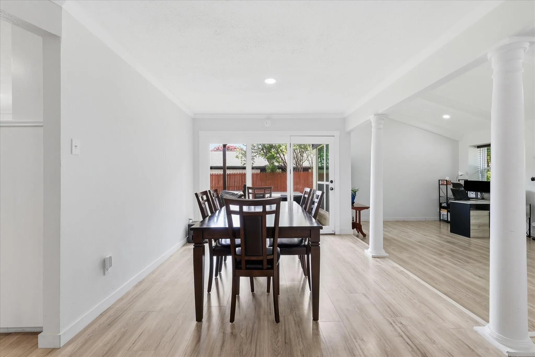 Dining area featuring light wood-finish flooring, recessed lighting, and white baseboards