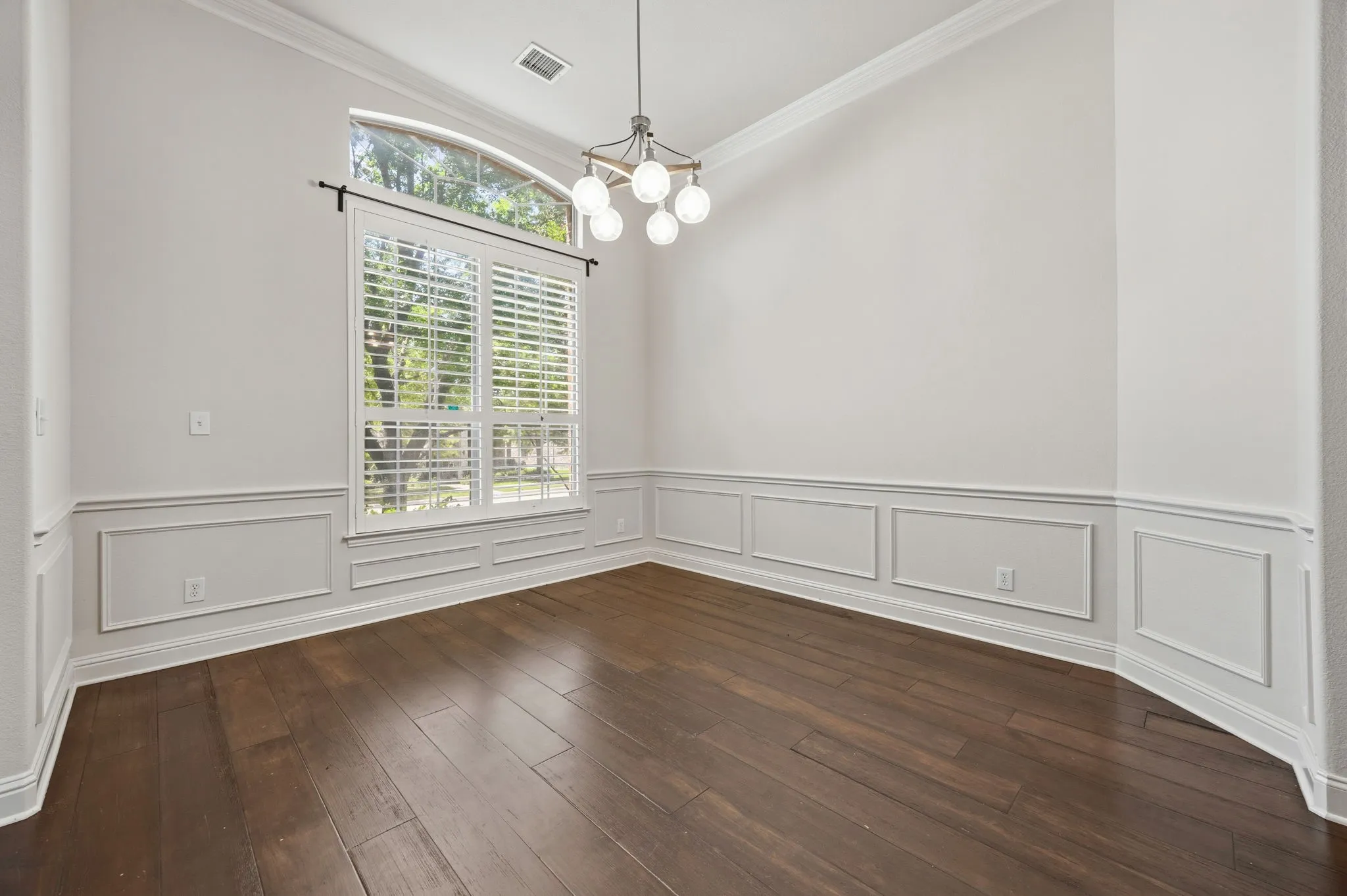 Formal Dining with huge window and wall paneling