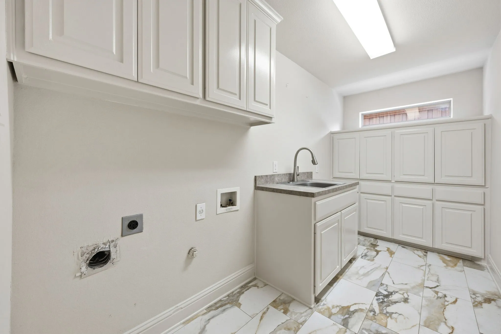 Laundry with storage cabinets and sink!