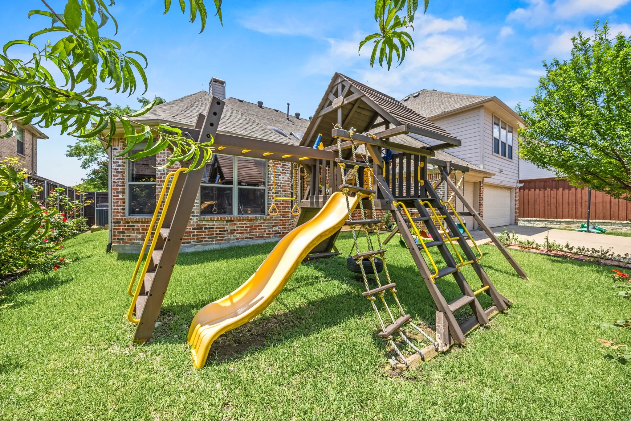 Children play set, roses and peach tree ready to fruit!