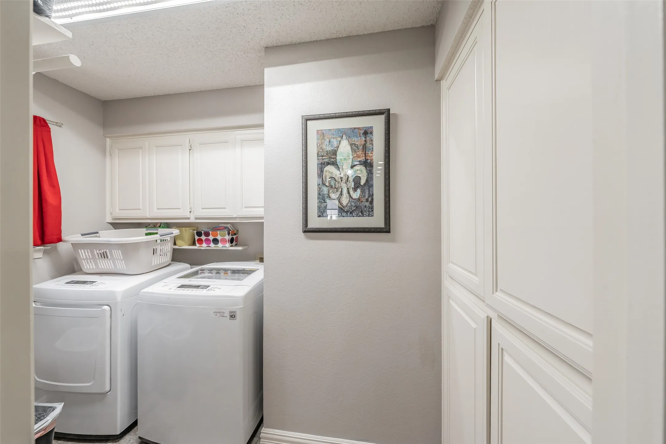 Laundry room is right off the kitchen and has lots of storage plus a drip dry area.