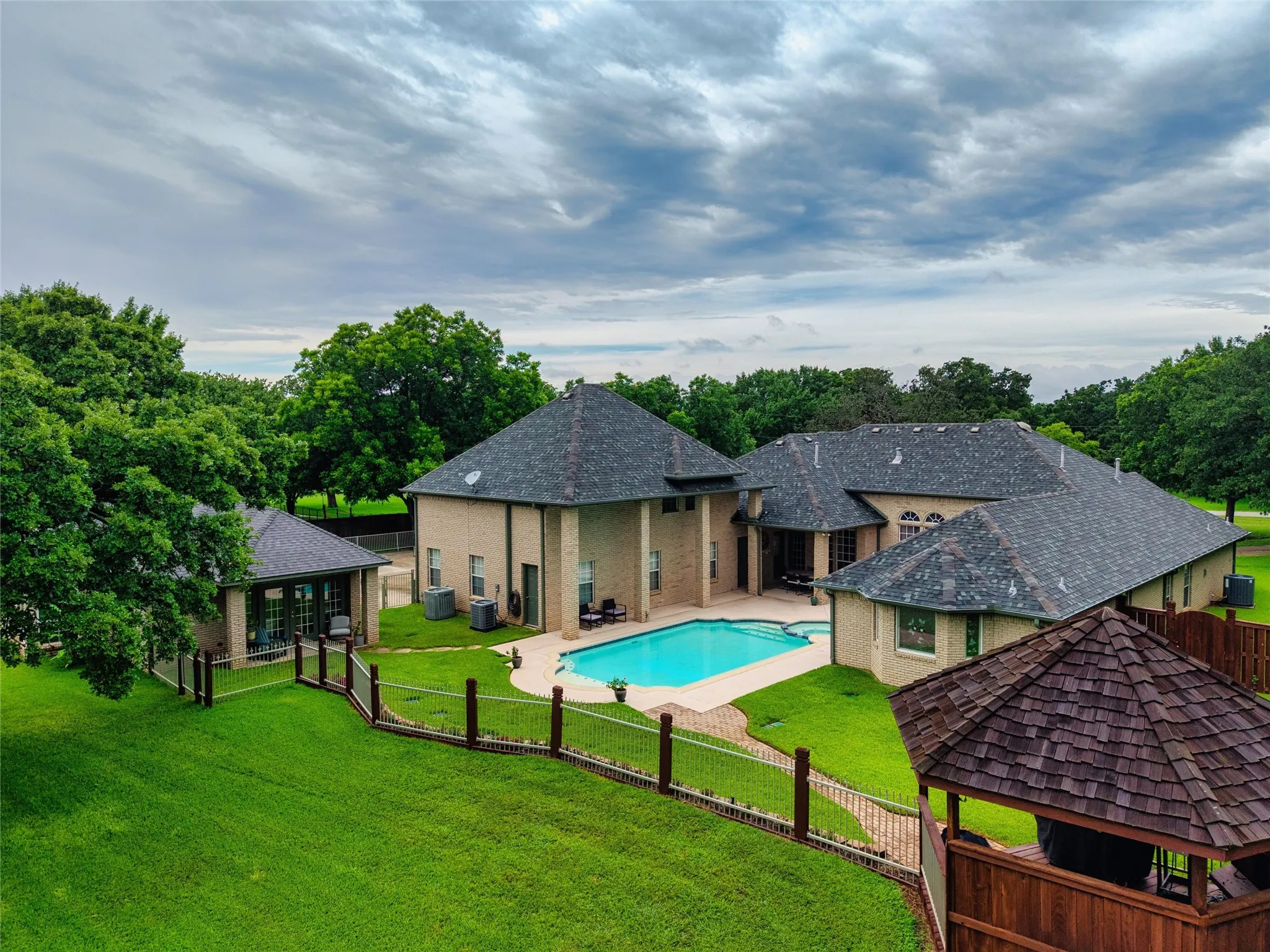 View of the property showing grand home, pool, spa, pergola and separate generational or  guest quarters.
