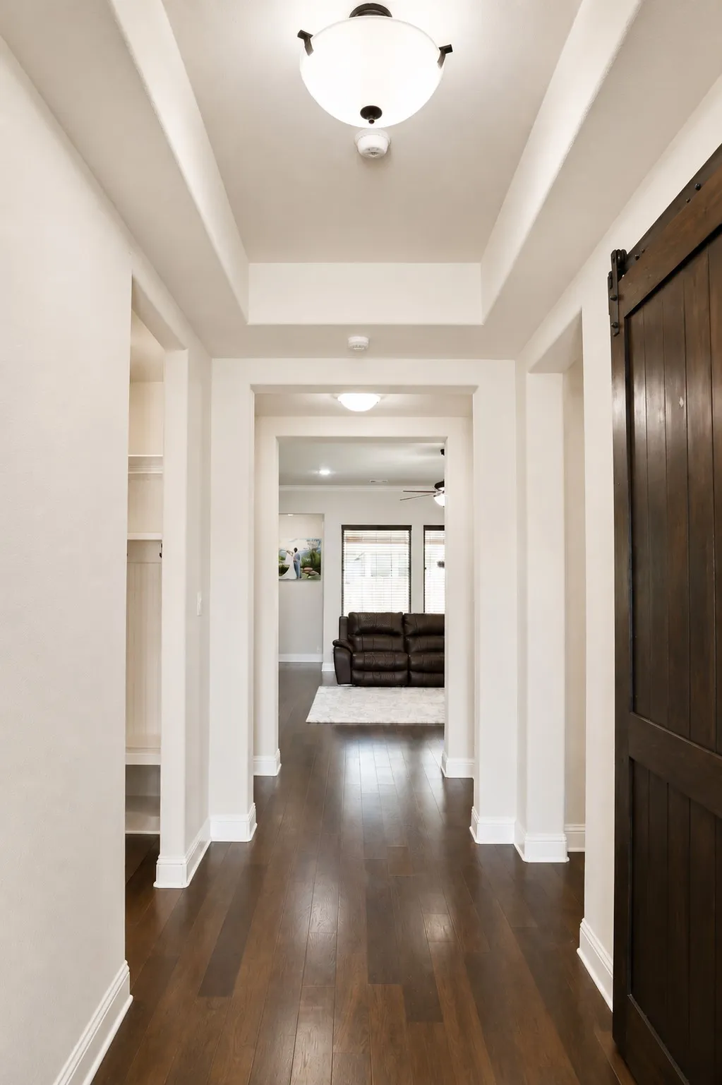 Entryway featuring tray ceilings and wood-finish​​‌​​​​‌​​‌‌​‌‌​​​‌‌​‌​‌​‌​​​‌​​ flooring