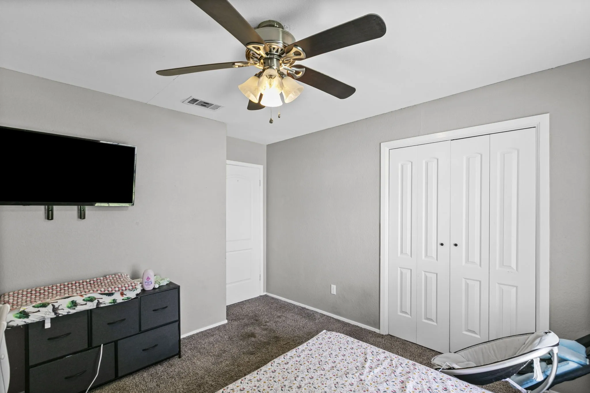 Bedroom featuring light grey walls and grey carpet flooring