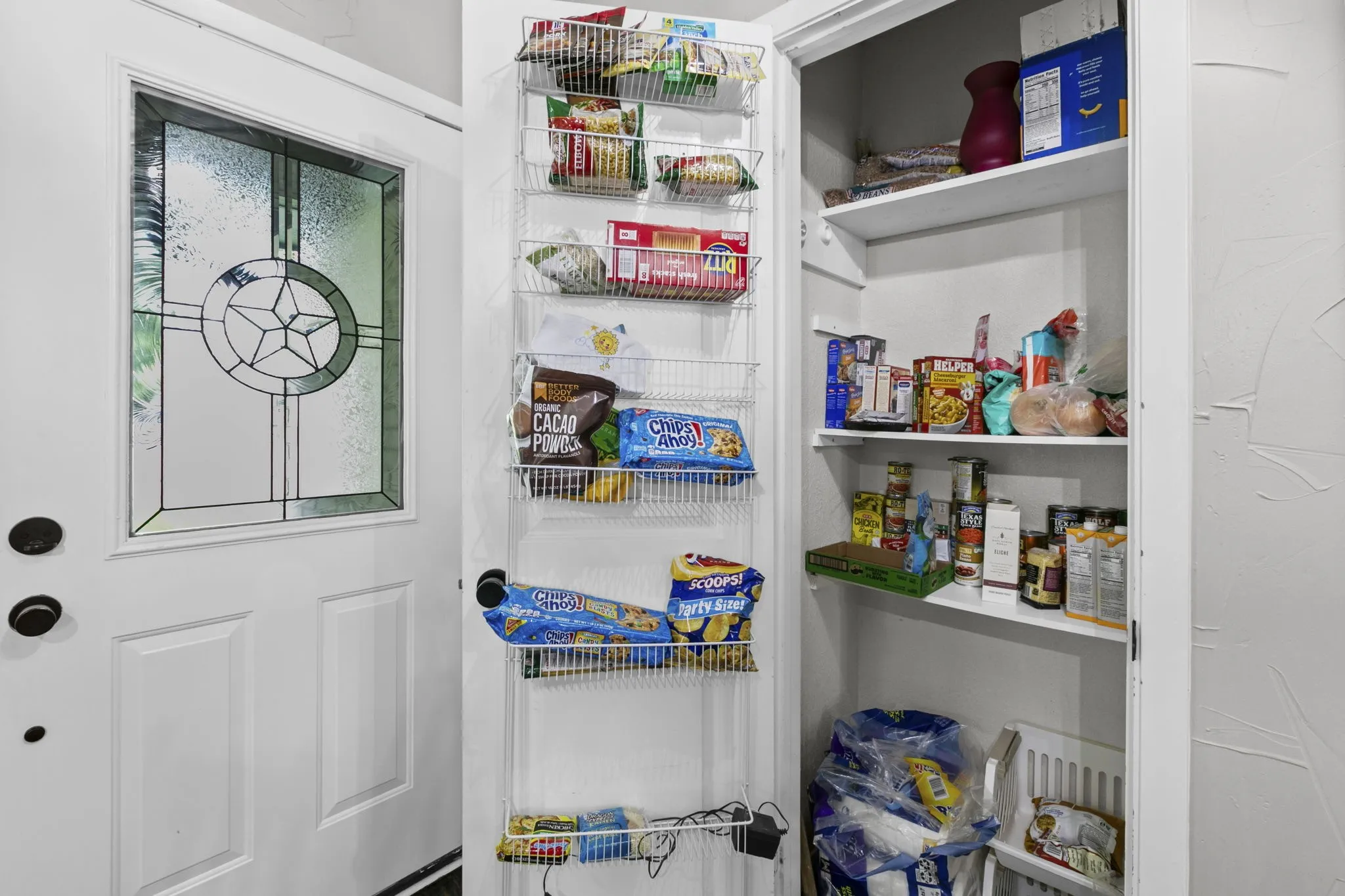 Pantry with multiple shelves and additional door-mounted storage