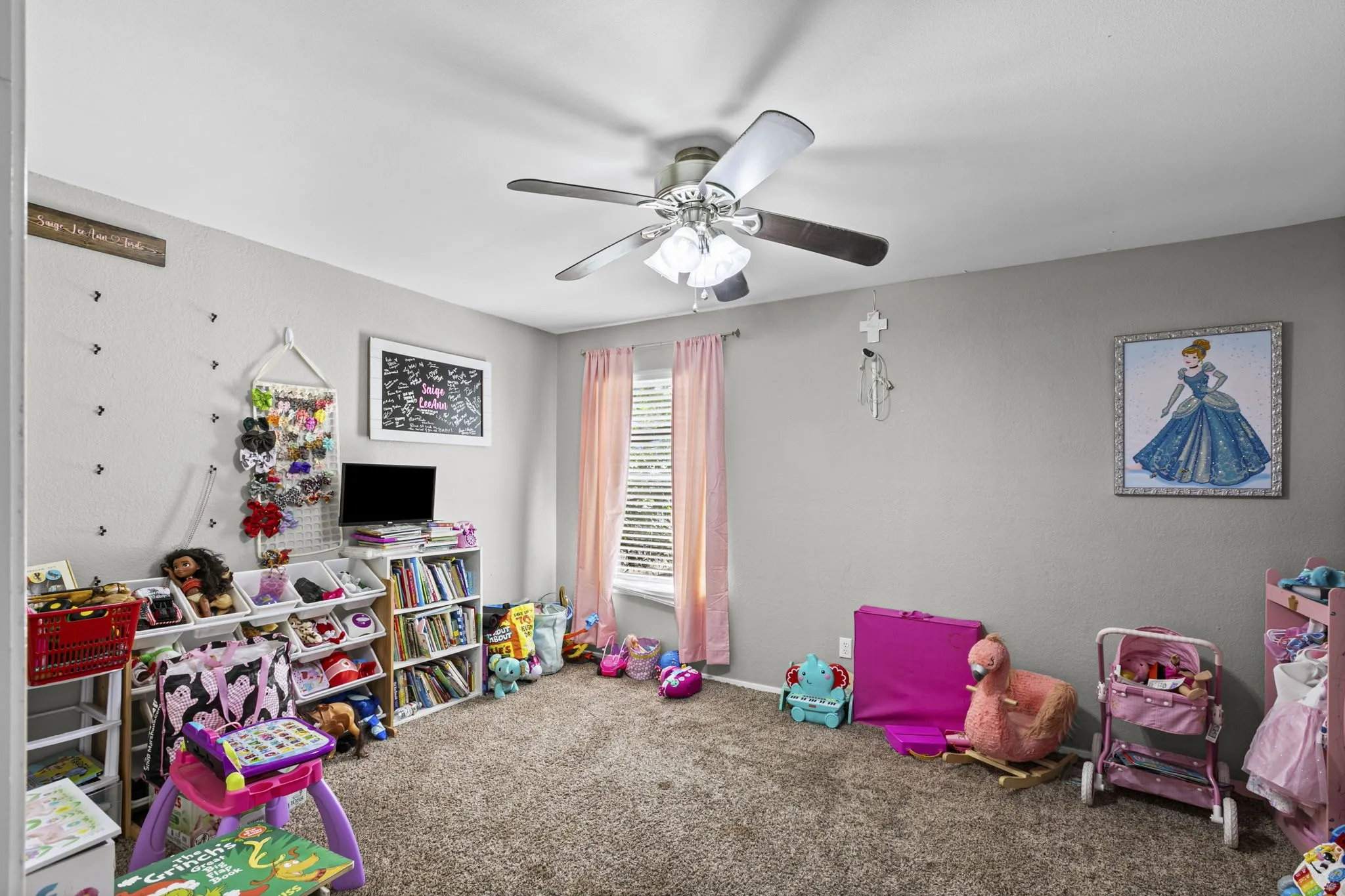 Spacious room featuring neutral painted walls and a textured carpet