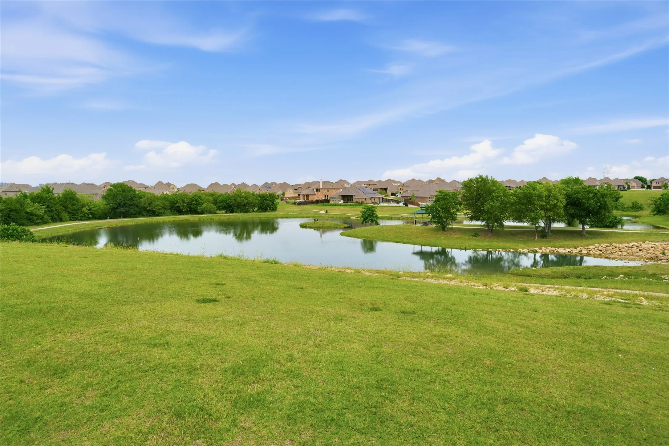 Expansive green space featuring one of many ponds