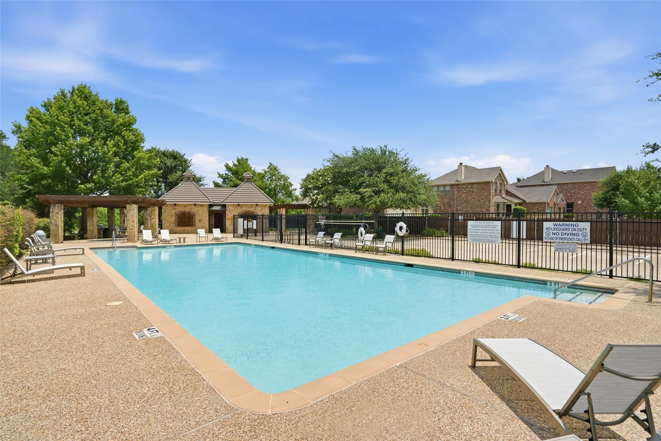 Community secondary swimming pool with decking and shaded space