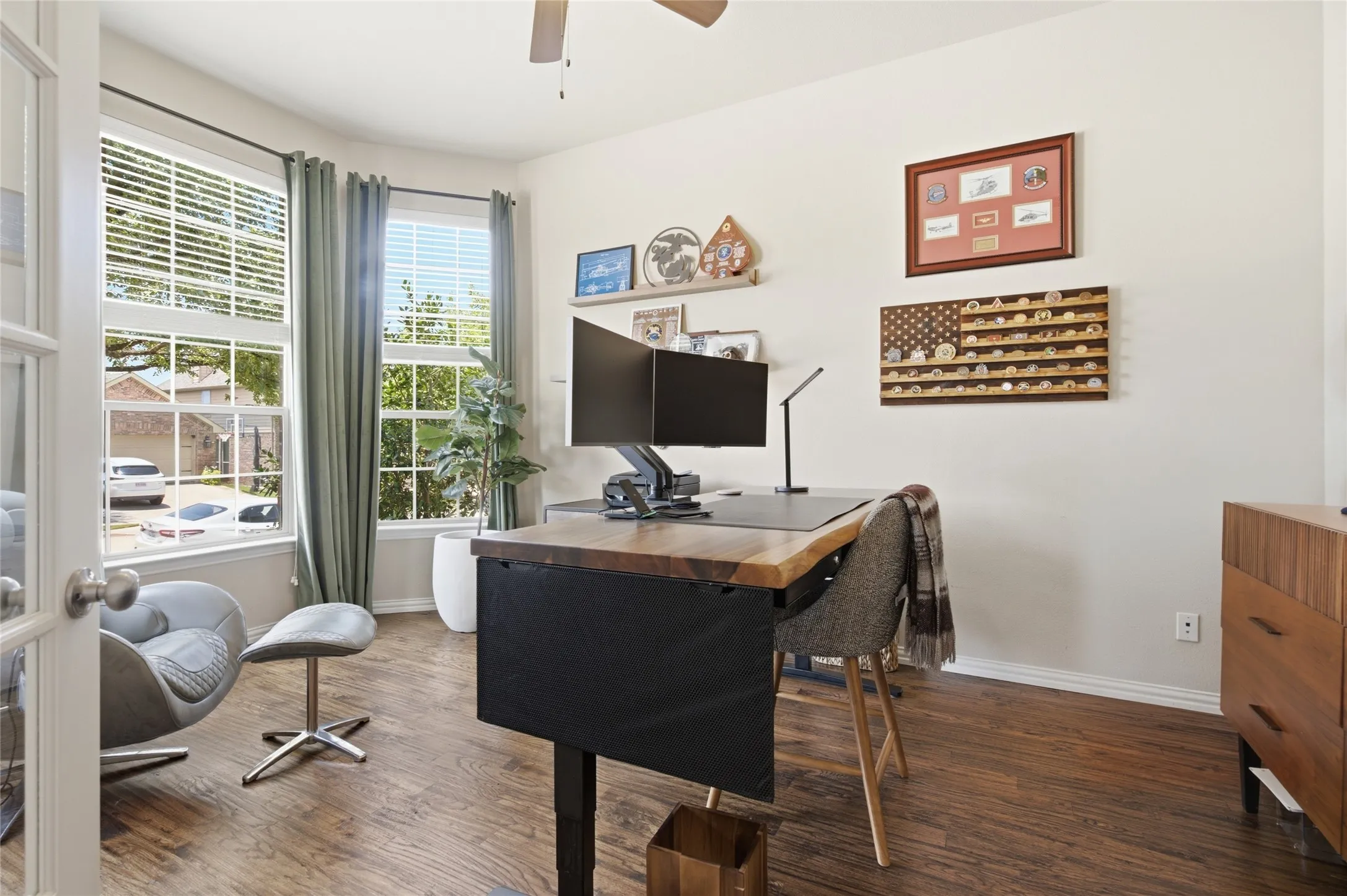 Office off front foyer features hardwood flooring, front views and a ceiling fan