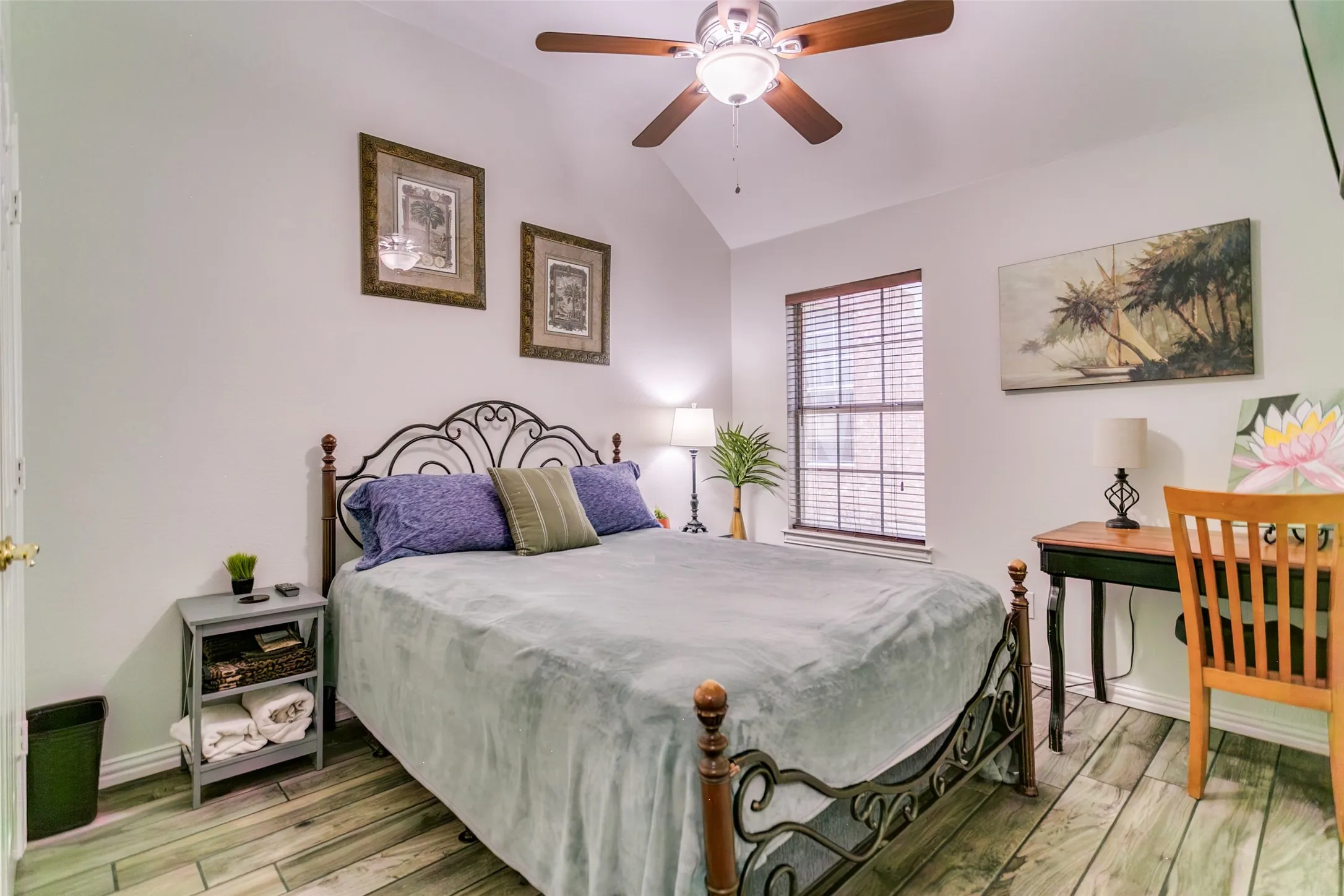 Secondary bedroom with high ceilings and new flooring.