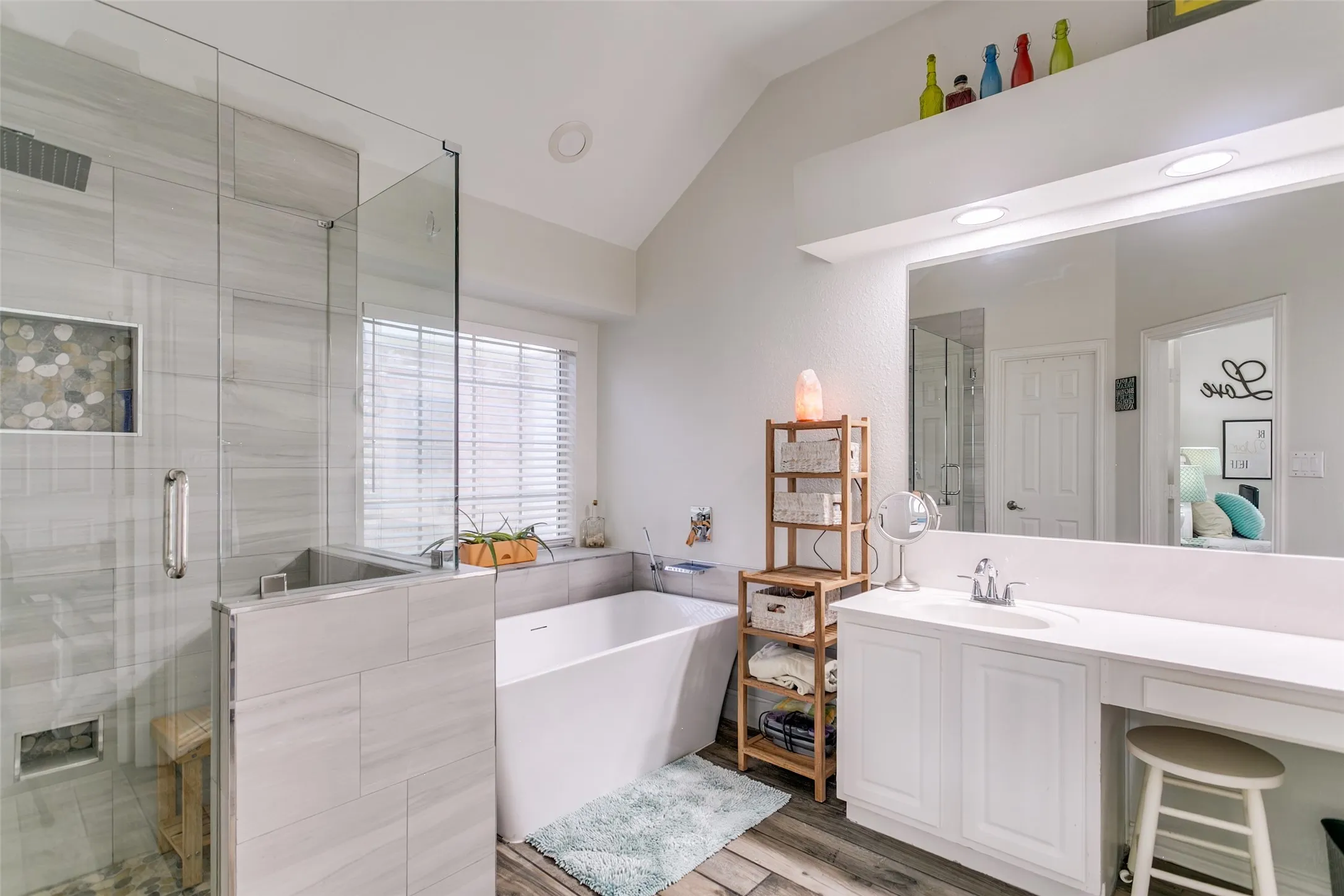 New remodeled primary bathroom with duel sinks, seamless glass shower and new tub.