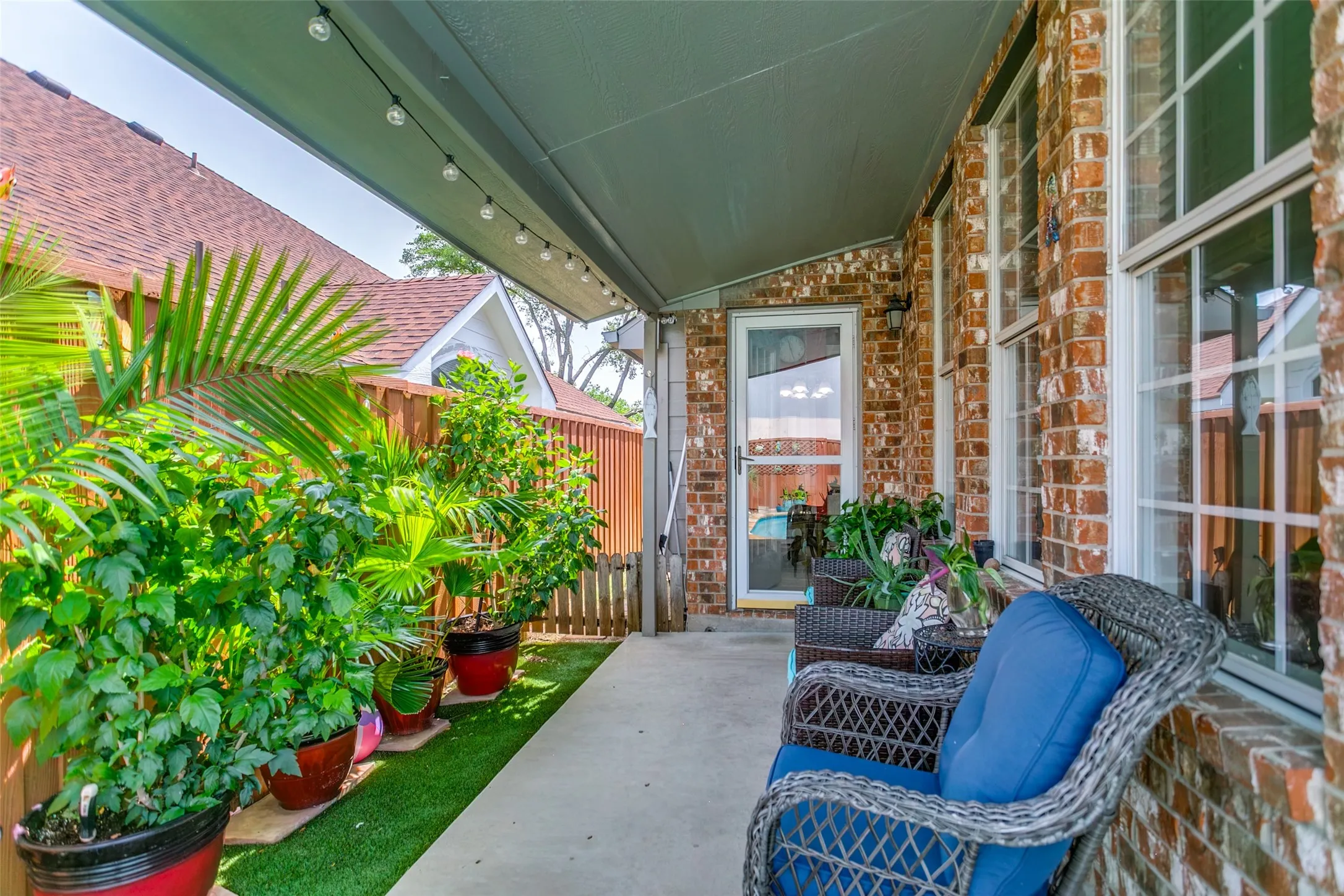 Covered patio and astro turf side yard. Gated dog run beside the house with a doggie door inside the house.