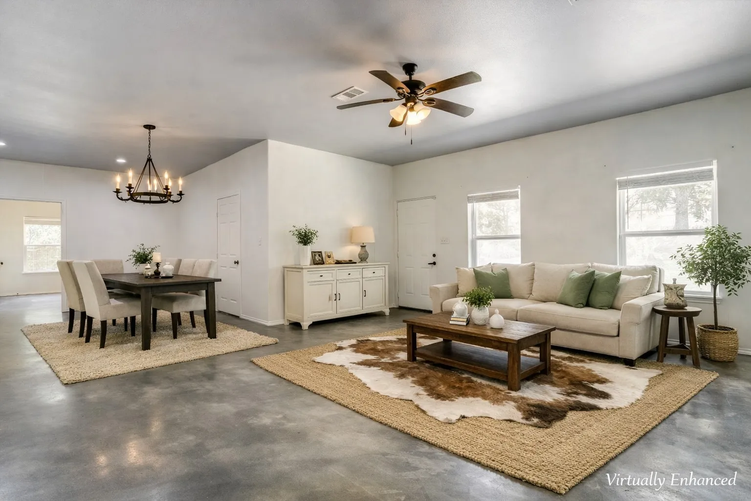 Open-concept living and dining area featuring polished concrete flooring, white walls, and abundant natural light from multiple windows