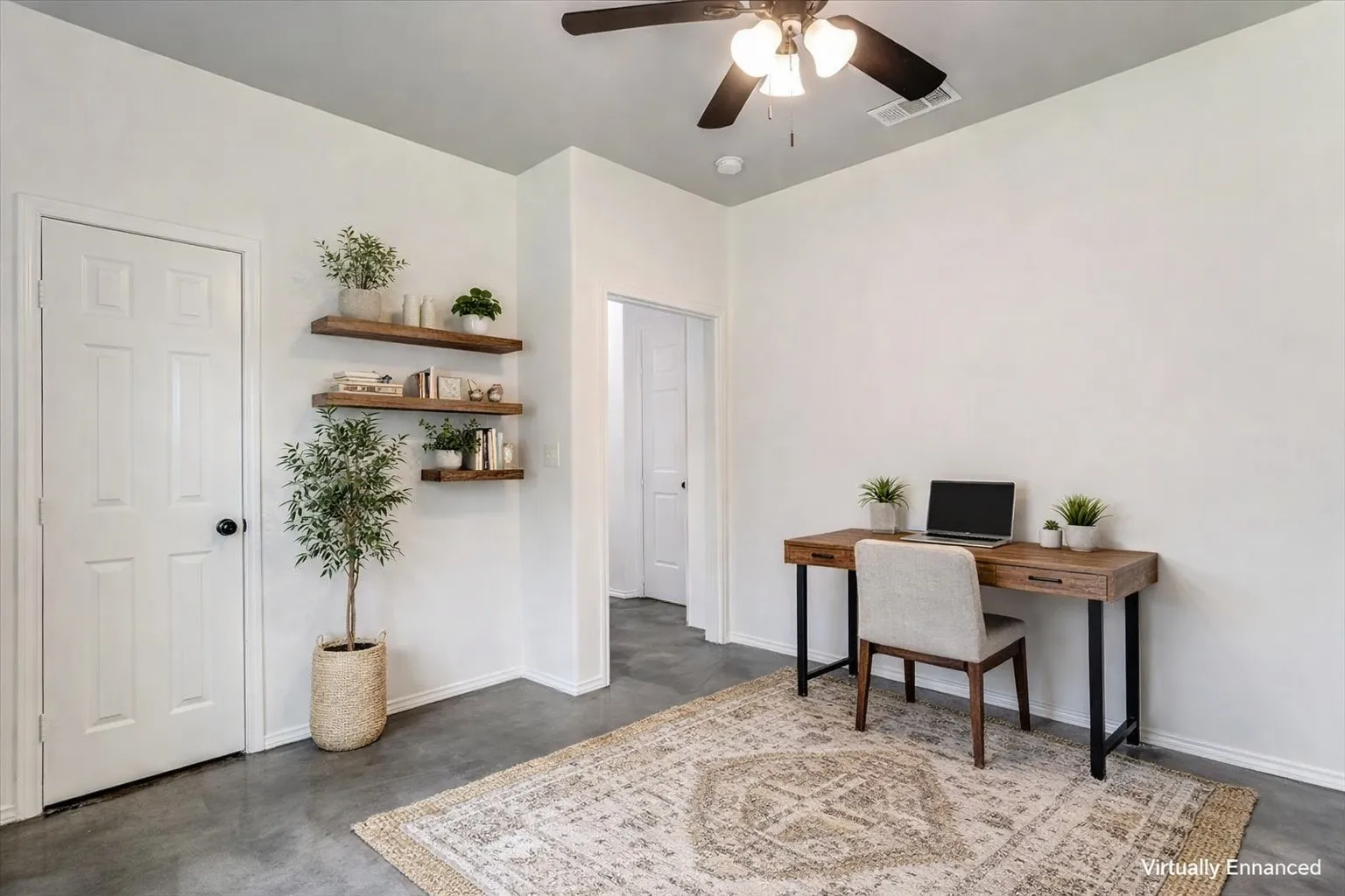 Room featuring wood-finish floating shelves, a ceiling fan with integrated lighting, two panel doors, and gray concrete flooring