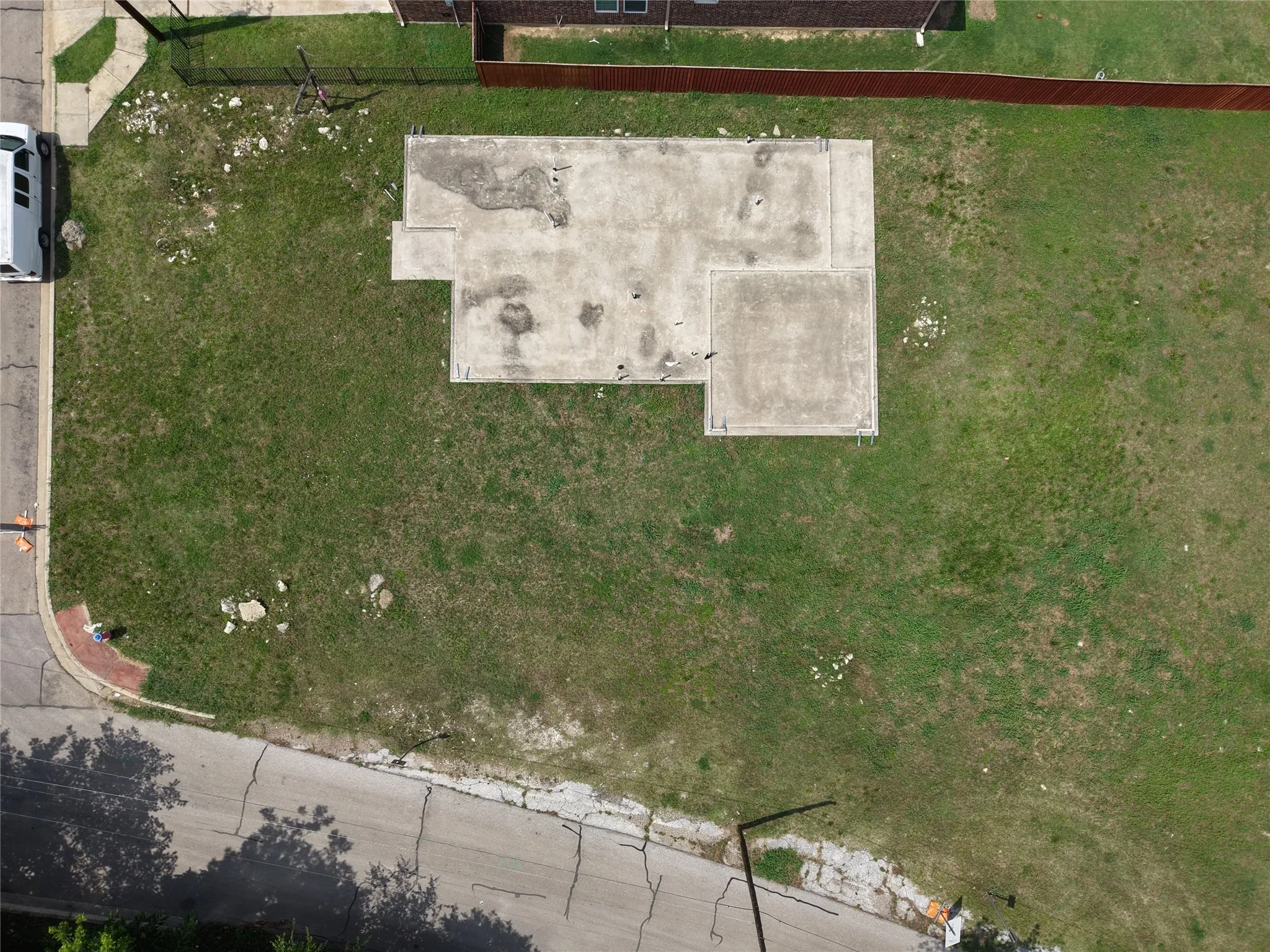 Expansive corner lot featuring a concrete foundation ready for construction