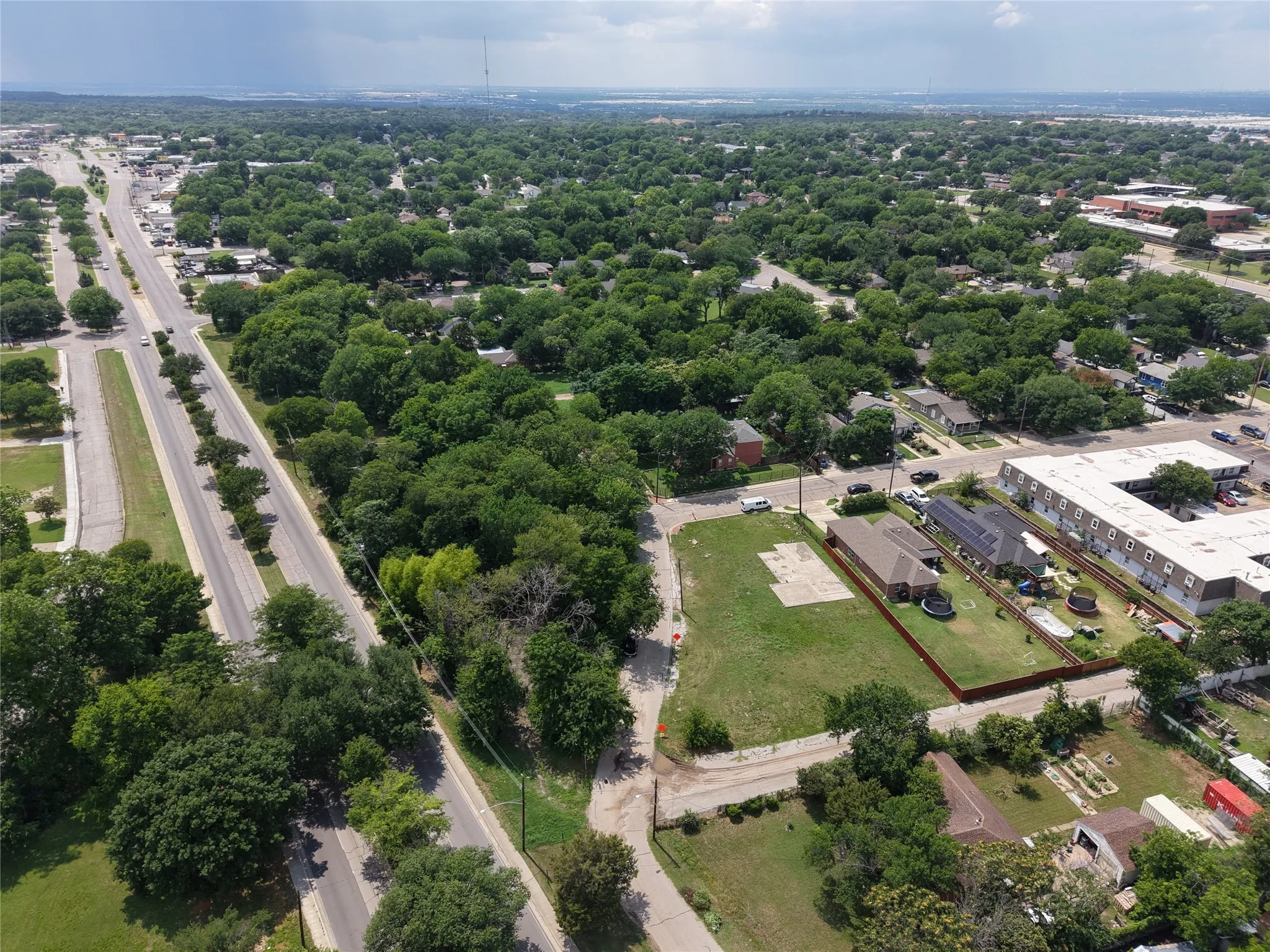Expansive residential parcel featuring a clear building footprint, established perimeter fencing, and mature surrounding trees