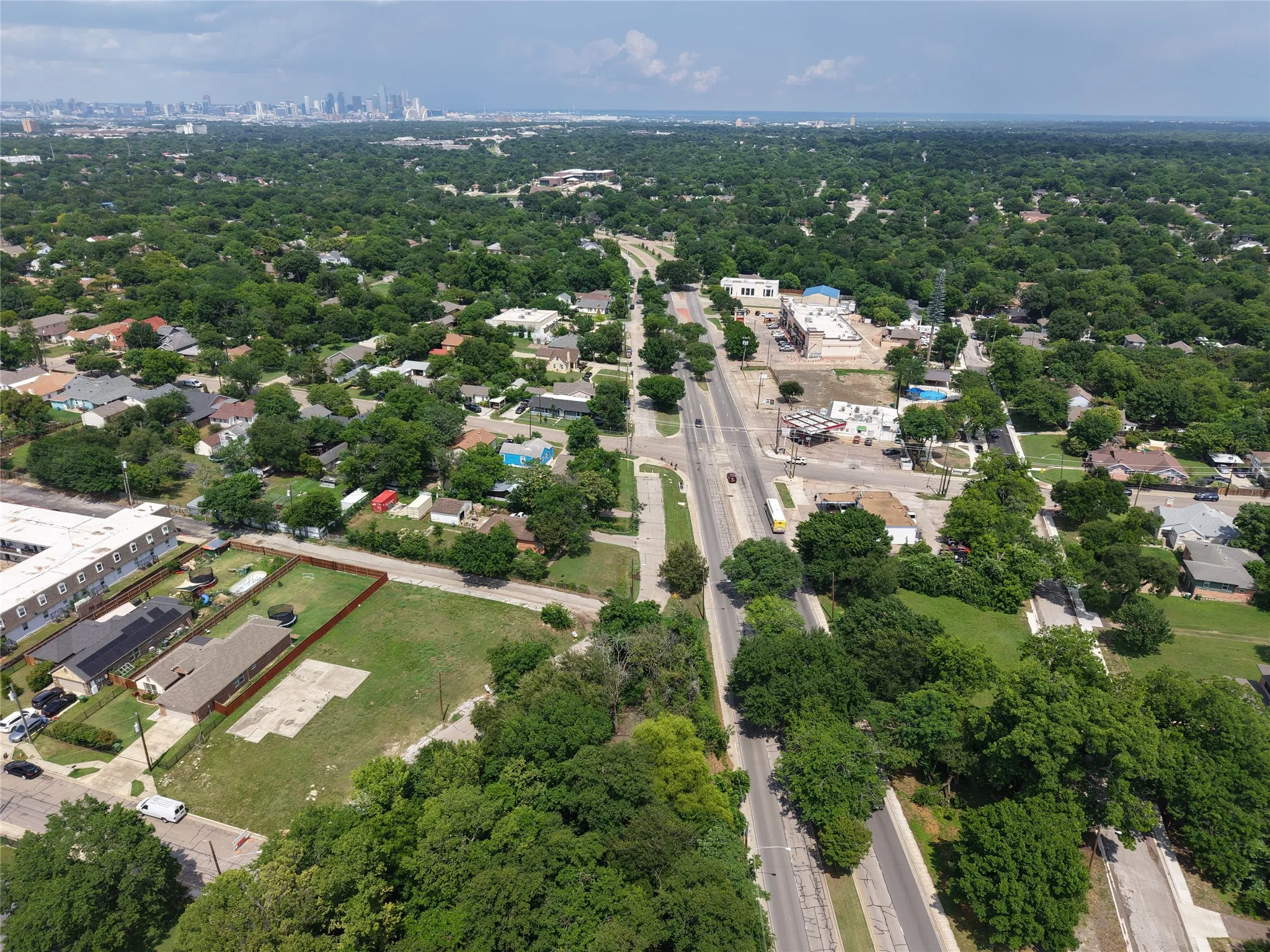Expansive land parcel featuring a perimeter fence and mature trees