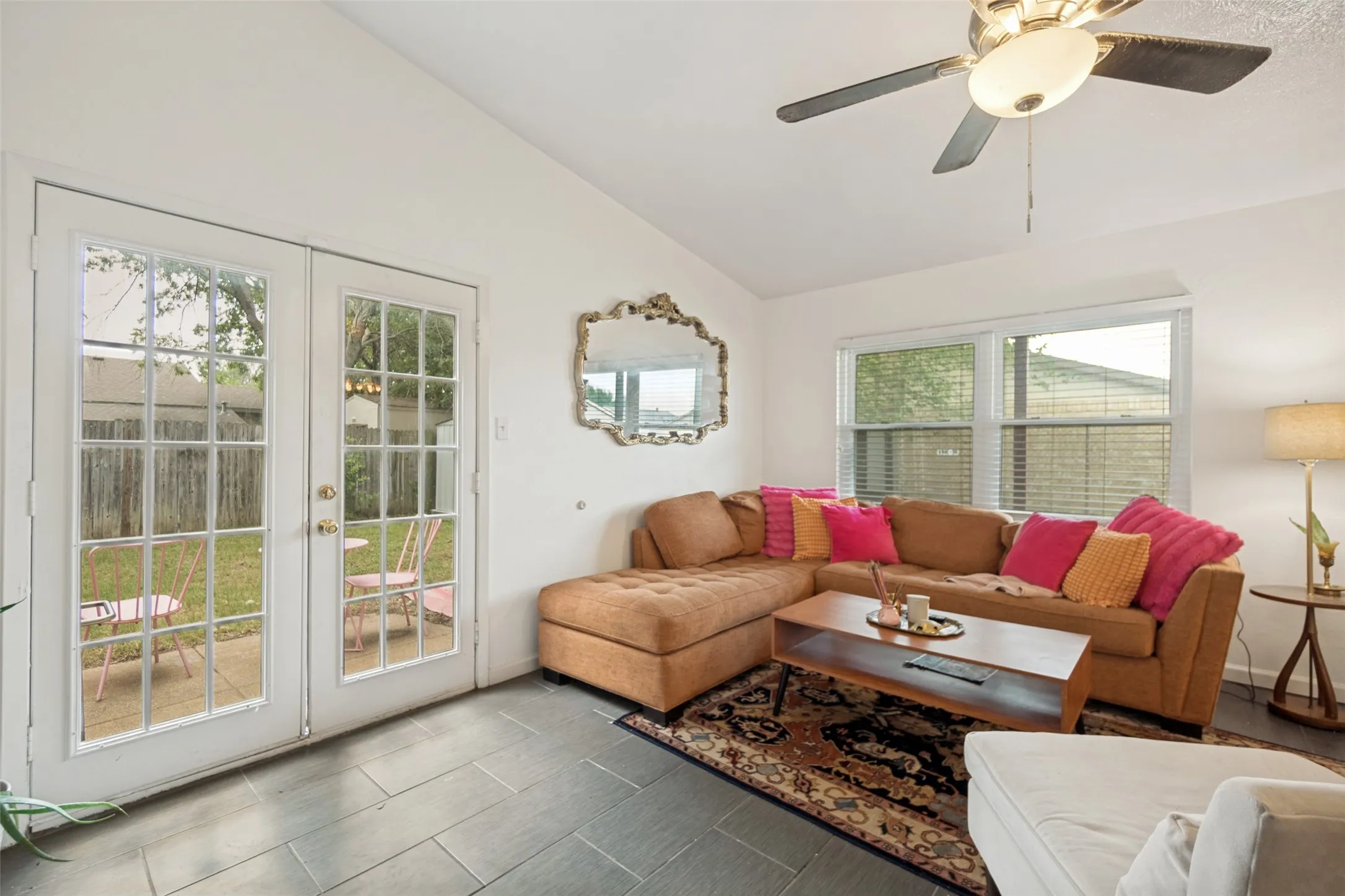 Living area featuring dark tile flooring and white walls