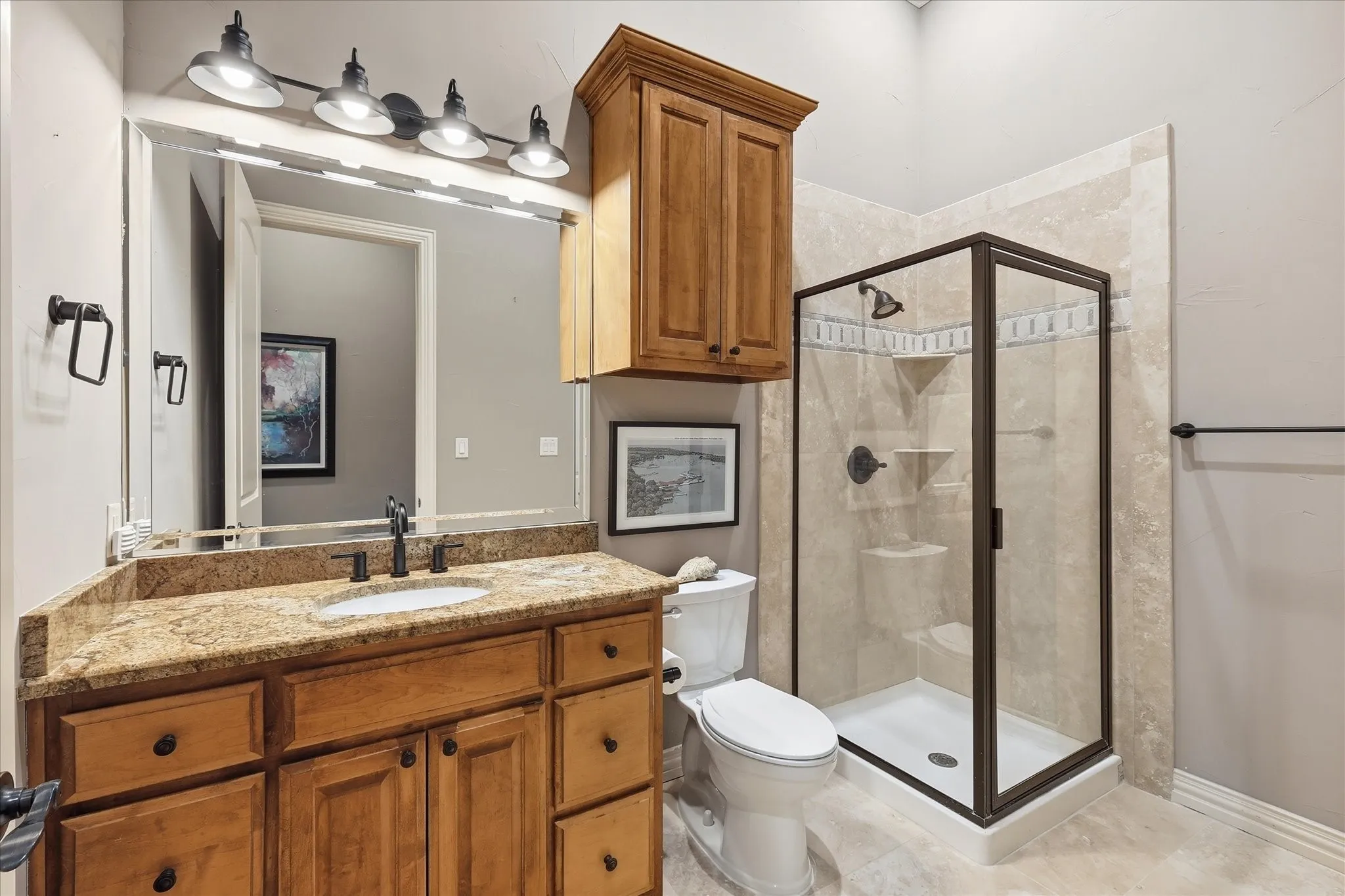 The 2nd floor full bath has new Turkish travertine flooring, new lighting, mirror and fixtures, knotty alder cabinetry and granite.