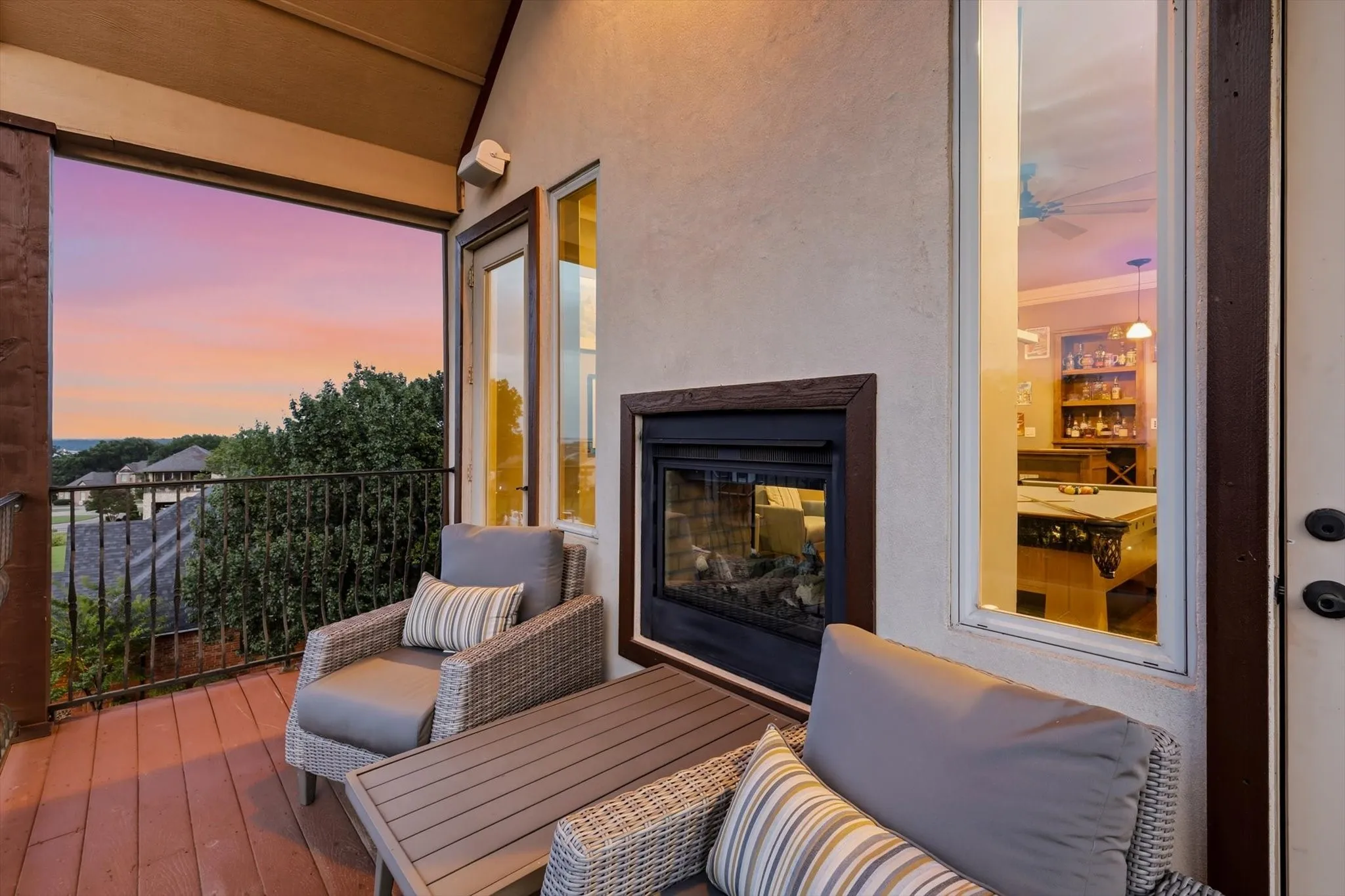 3rd story balcony with panoramic lake and sunset views from all sides, see through gas fireplace, wrought iron railing and Trex decking.