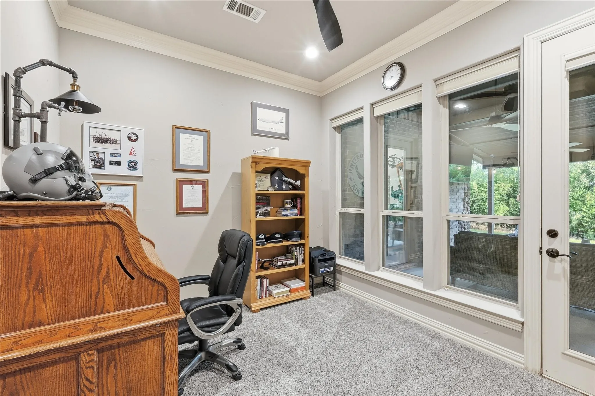 The office is on the 1st floor and has double crown molding and new ceiling fan. There is access to the back 1st floor patio.