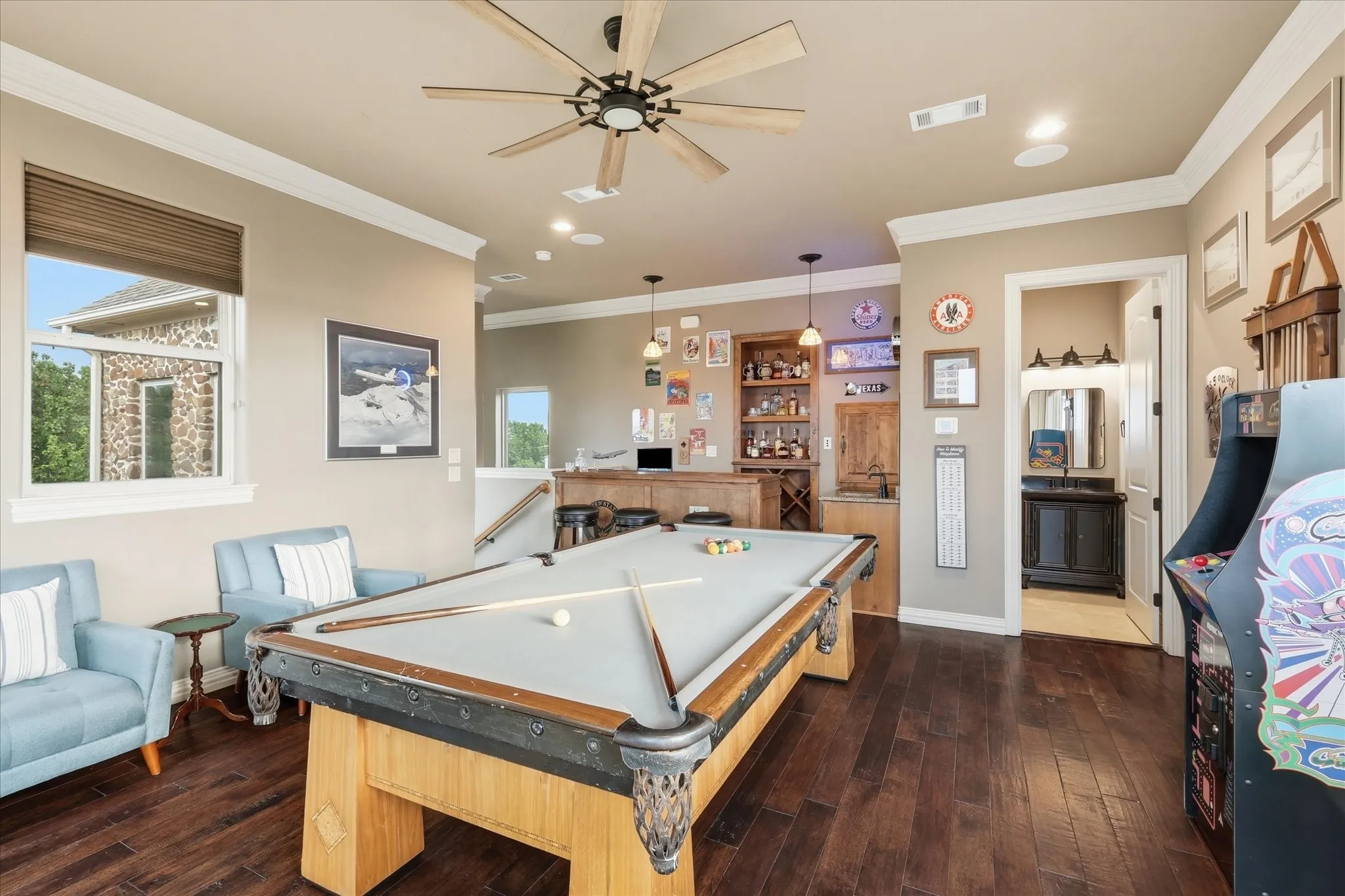The game room has a half bath and gorgeous custom bar.