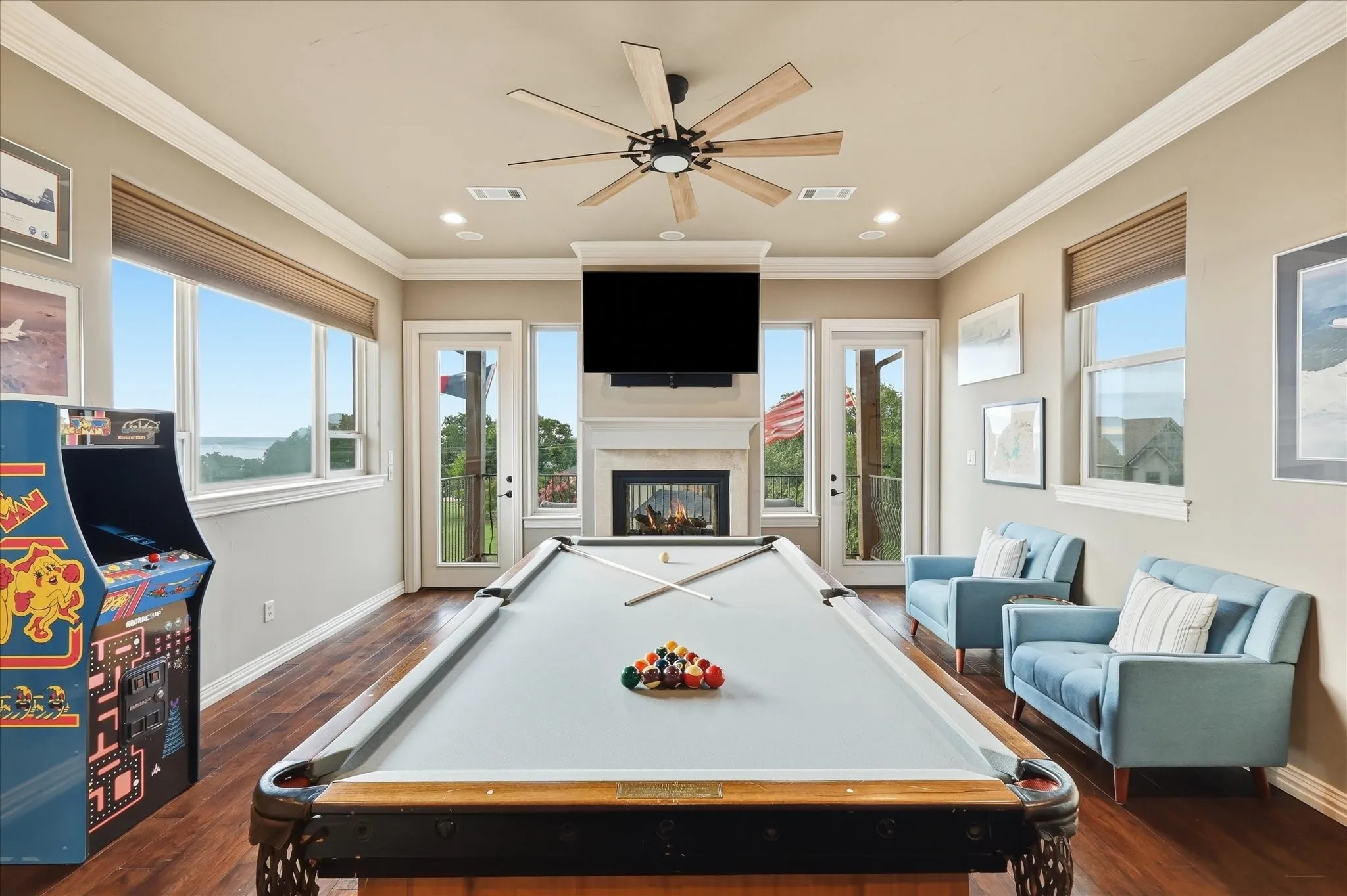 The 3rd floor is a large game room. There's a see through gas fireplace, double crown molding, 10'ceilings, new ceiling fan and 2 exterior access doors that lead onto the 3rd story balcony. The pool table conveys!
